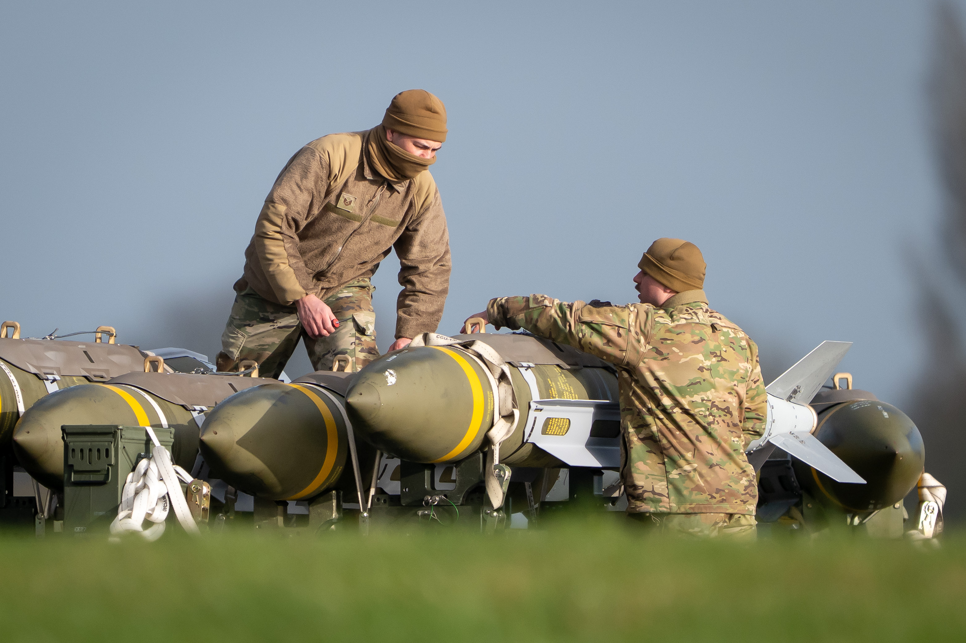 FAIRFORD, ENGLAND - MARCH 15: Servicemen inspect bombs after they were unloaded from a C-130J-30 Super Hercules shortly after landing at RAF Fairford on March 15, 2026 in Fairford, England. The United States is using the RAF base as part of its military operations in Iran. (Photo by Matthew Horwood/Getty Images)