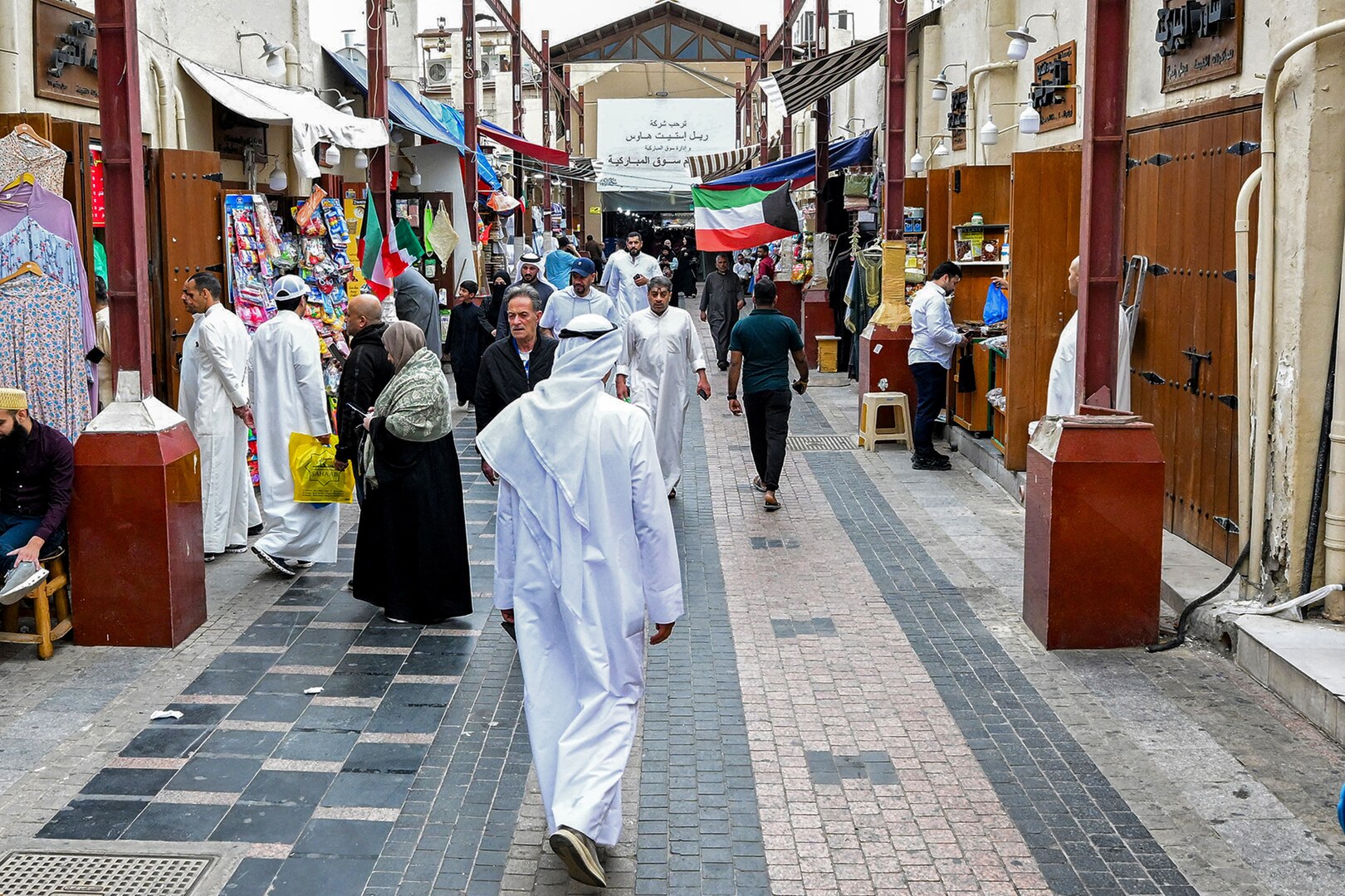 People walk along an alley at a traditional market in Kuwait City on March 19, 2026, ahead of Eid al-Fitr, the holiday marking the end of the Muslim holy fasting month of Ramadan. [Yasser Al-Zayyat/AFP]