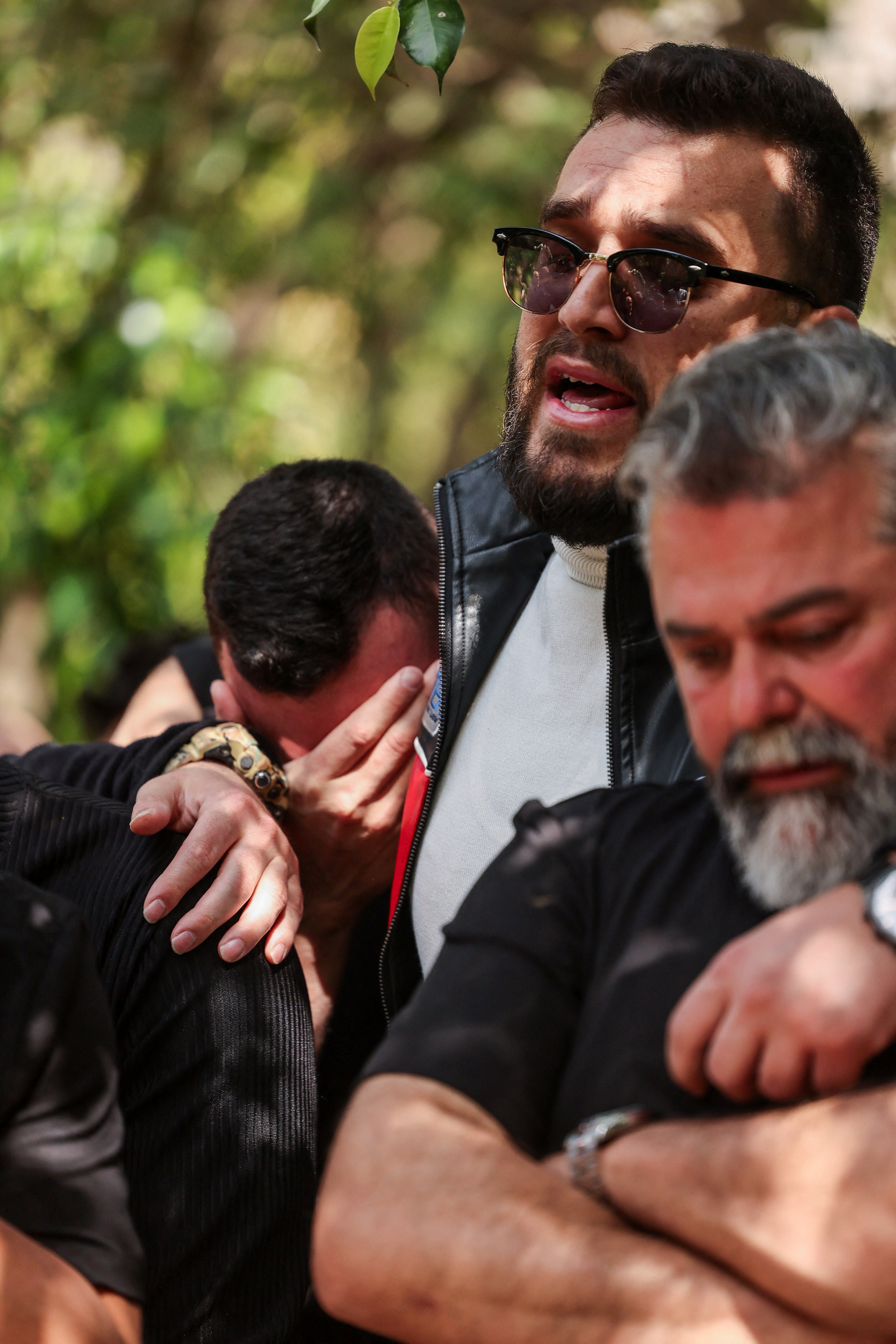 Mourners react during a funeral.