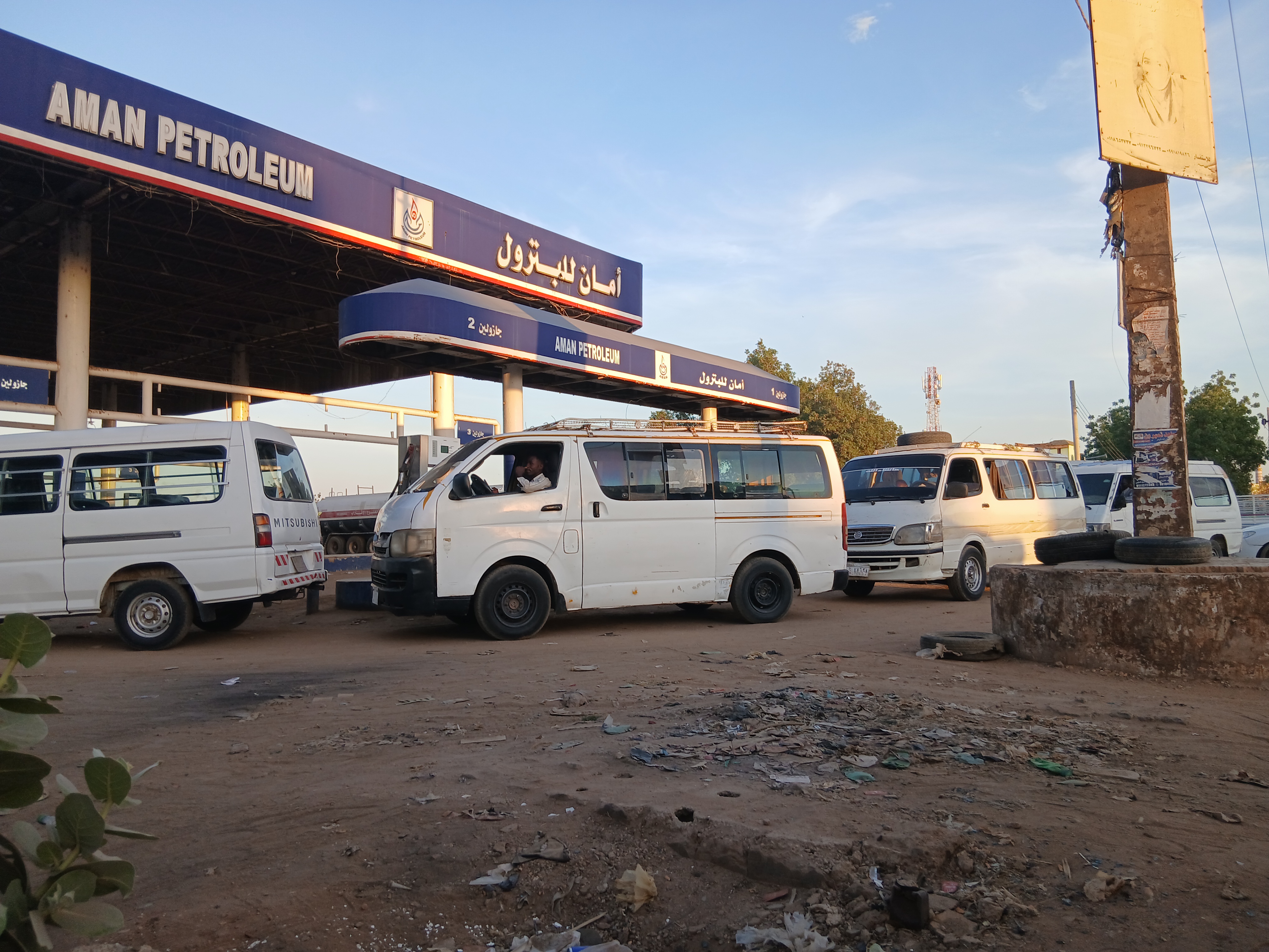 Vans line up at a petrol station