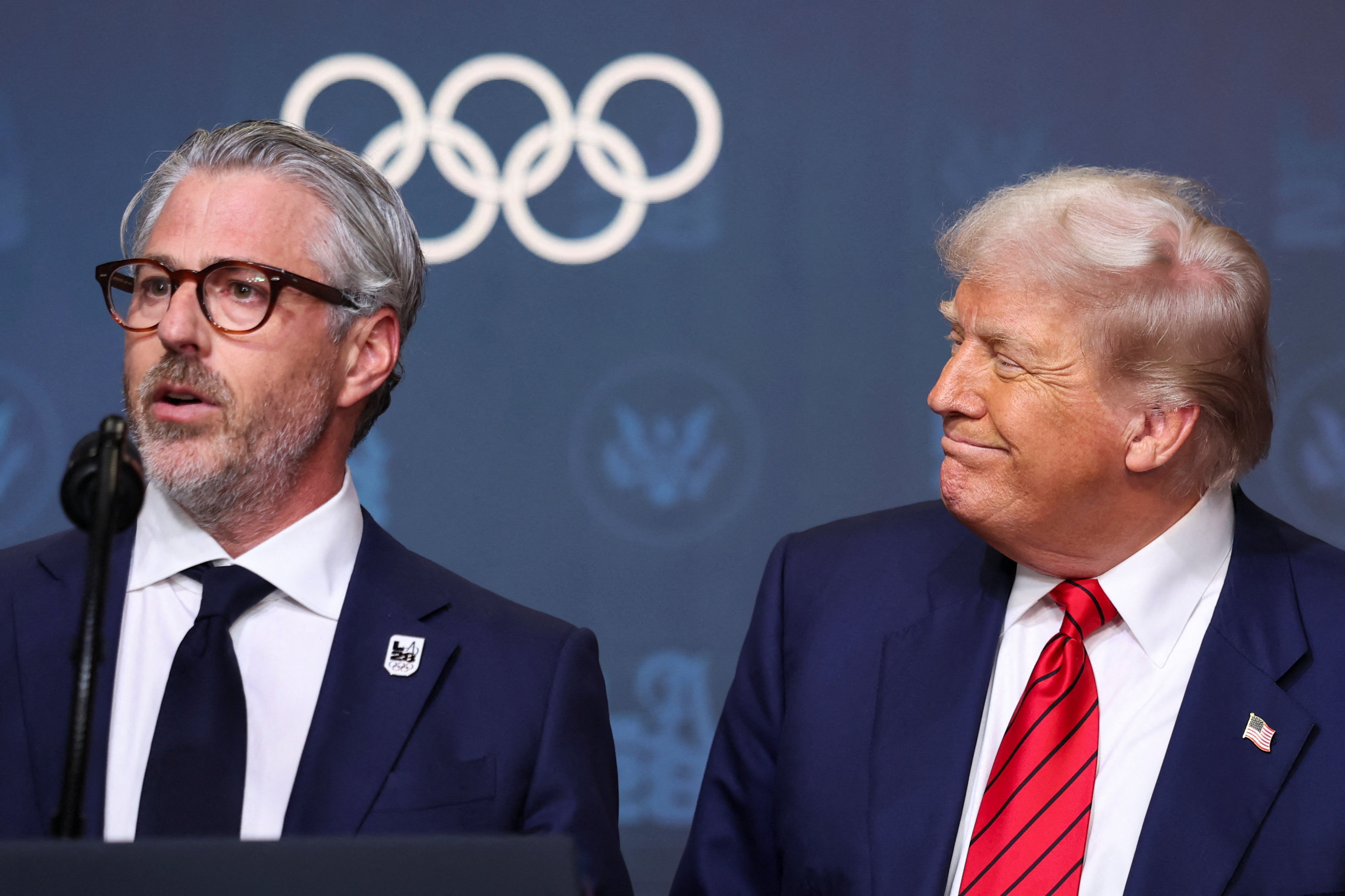 U.S. President Donald Trump reacts, as LA28 Chairman Casey Wasserman speaks, before signing an executive order to create a White House Olympics task force to handle security and other issues related to the LA 2028 summer Olympic games