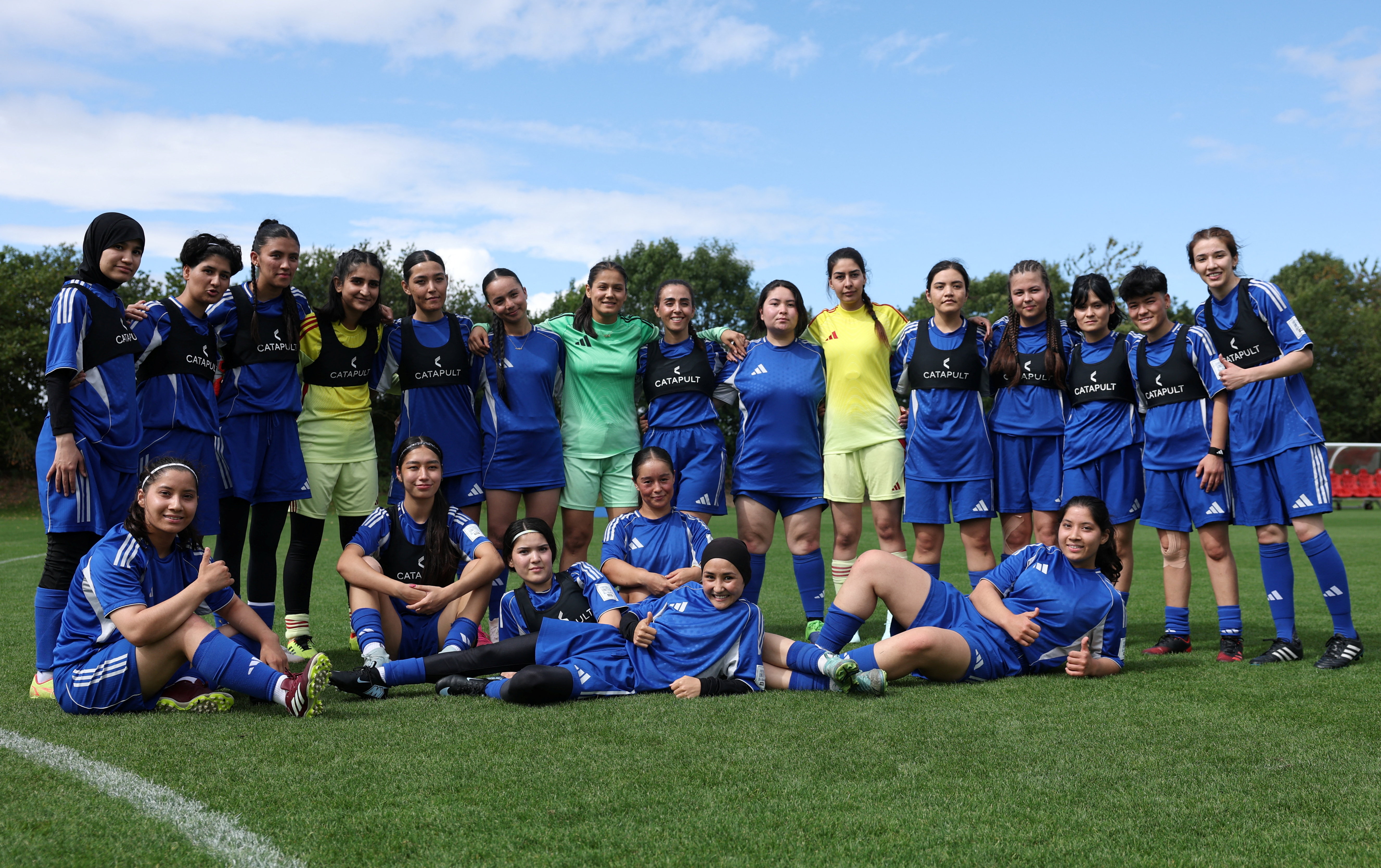 Soccer Football - Members of the Afghan Women's Refugee team pose for a team group during a selection camp at St. George's Park, Burton upon Trent, Britain - August 26, 2025 REUTERS/John Sibley