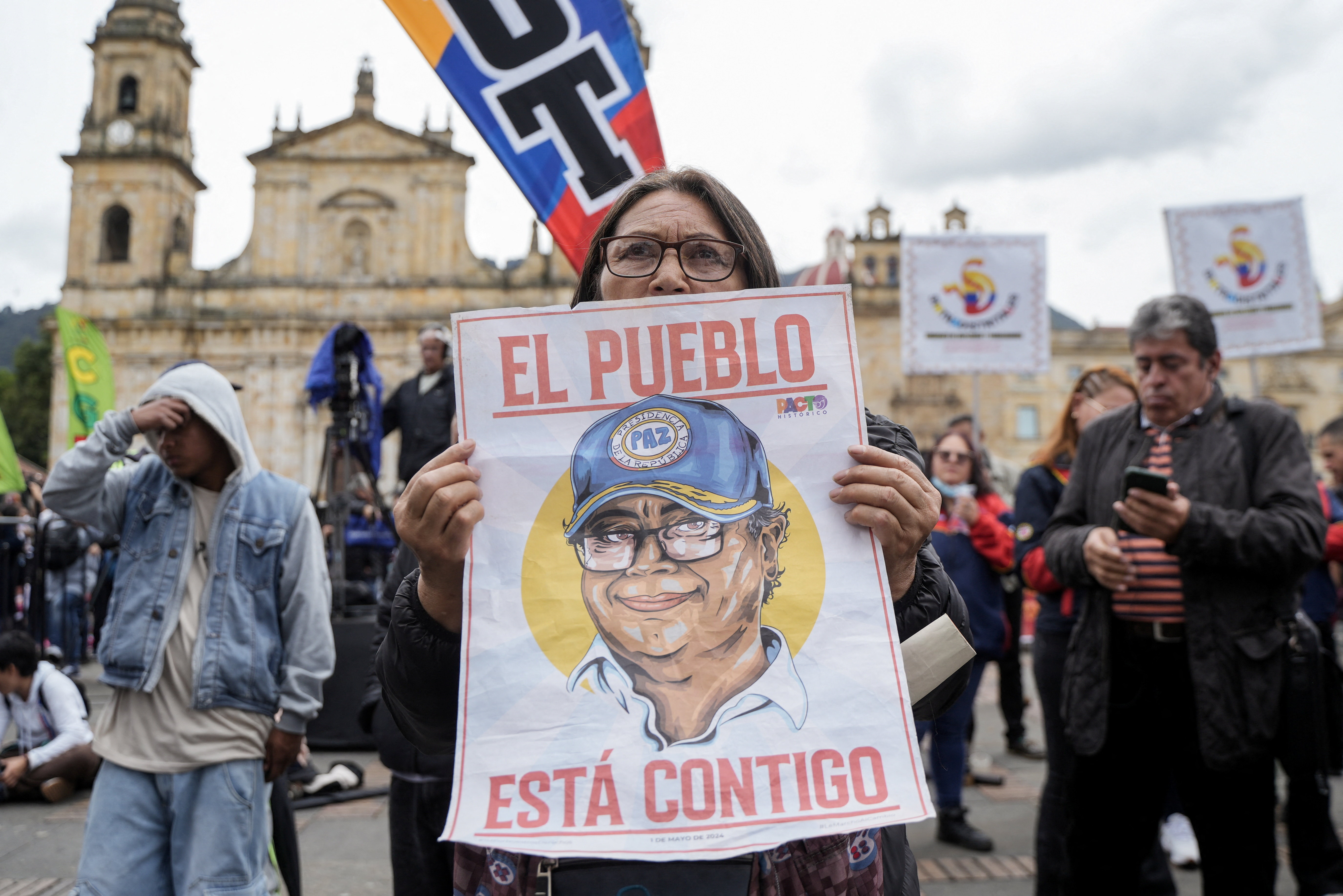 A woman holds a placard with the slogan "The people are with you" as people gather for a rally, called by the Colombian government, in support of President Gustavo Petro during his visit to the U.S., at Plaza Bolivar in Bogota, Colombia, February 3, 2026. REUTERS/Nathalia Angarita