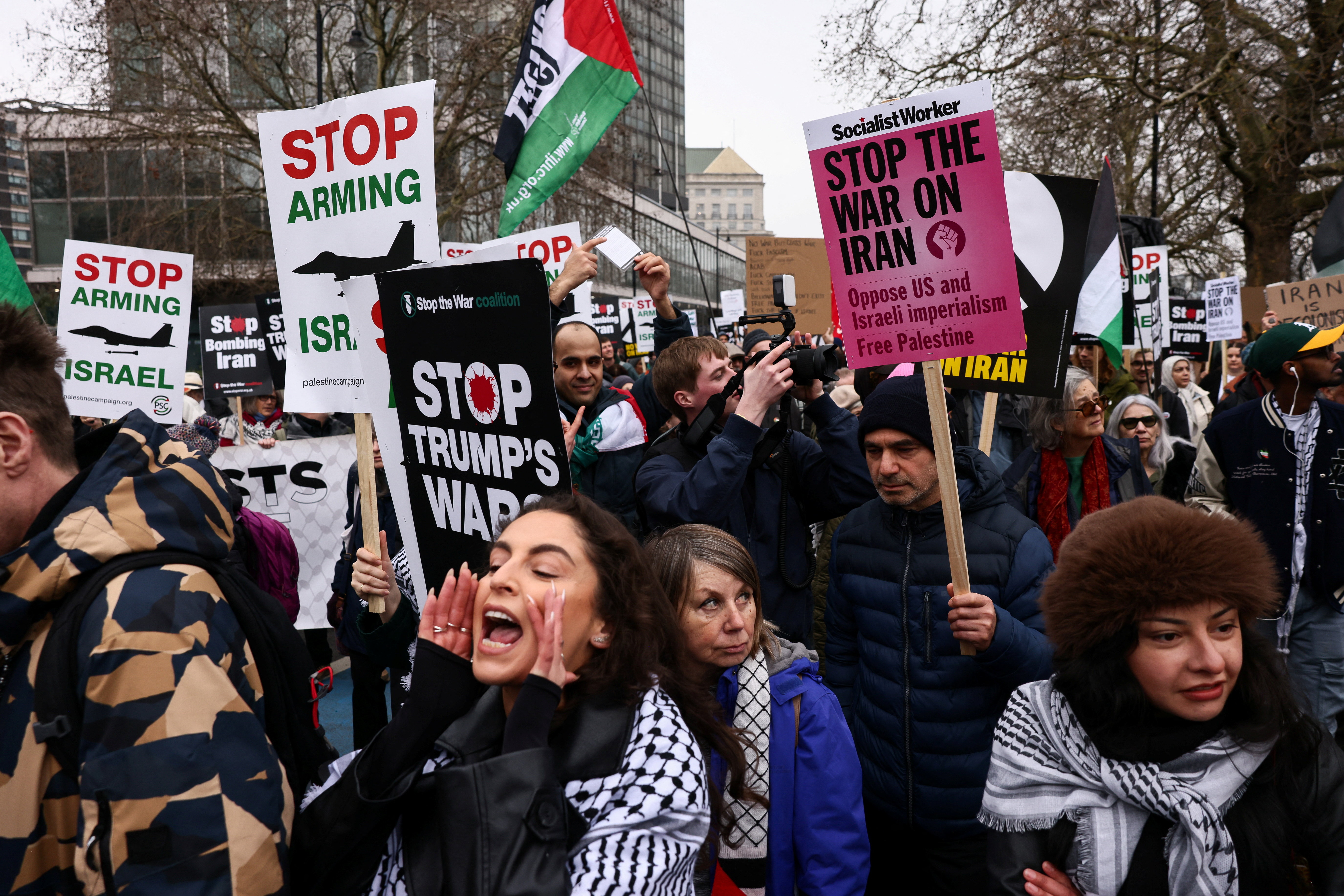 Anti-war activists hold signs during a march organised by Stop the War Coalition, calling for an end to hostilities amid the U.S.-Israeli conflict with Iran, in London, Britain, March 7, 2026. REUTERS/Jack Taylor