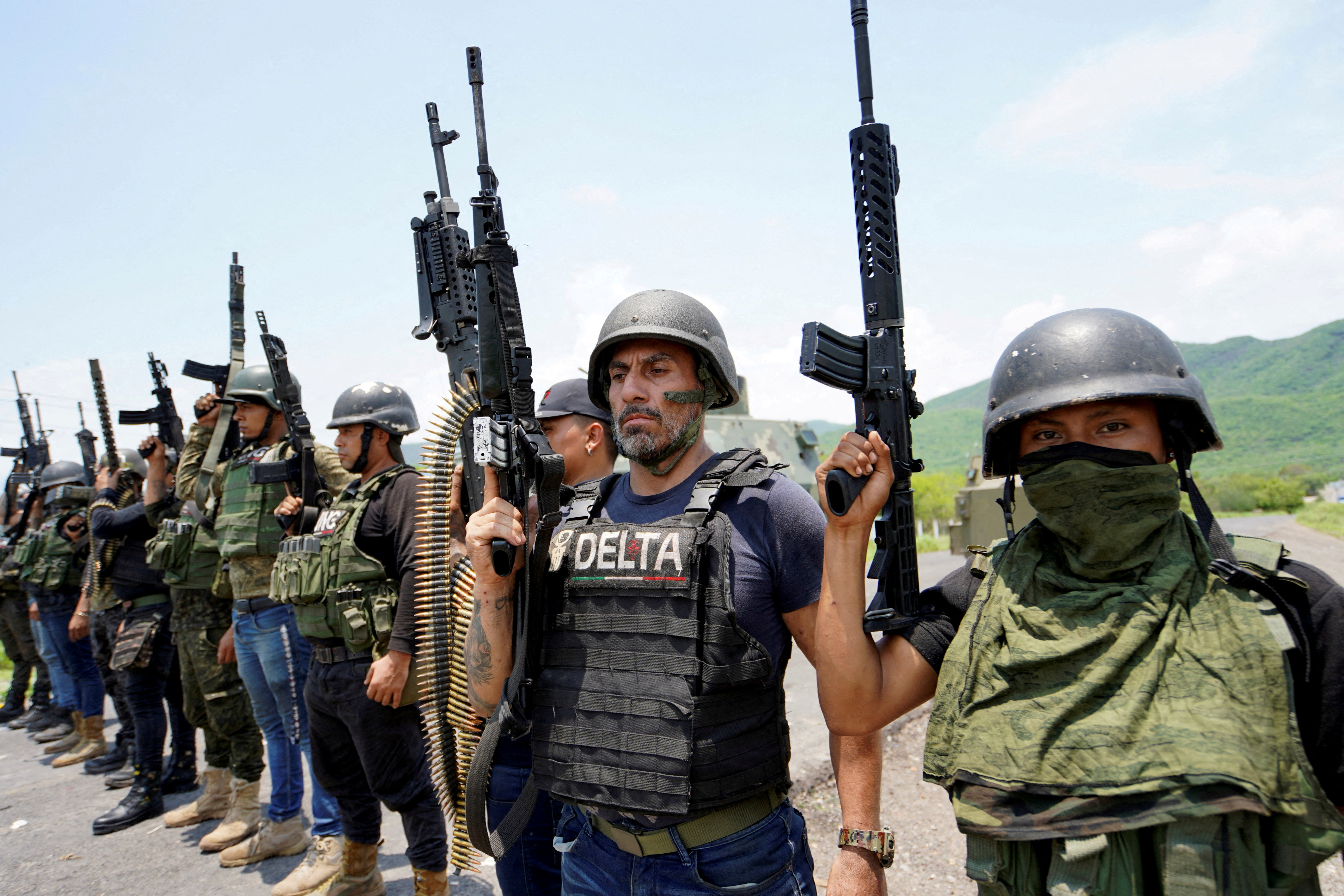 Members of the Jalisco New Generation Cartel (CJNG), led by Nemesio Oseguera, known as “El Mencho,” pose for a photo at an undisclosed location in Michoacan state, Mexico, July 1, 2021.