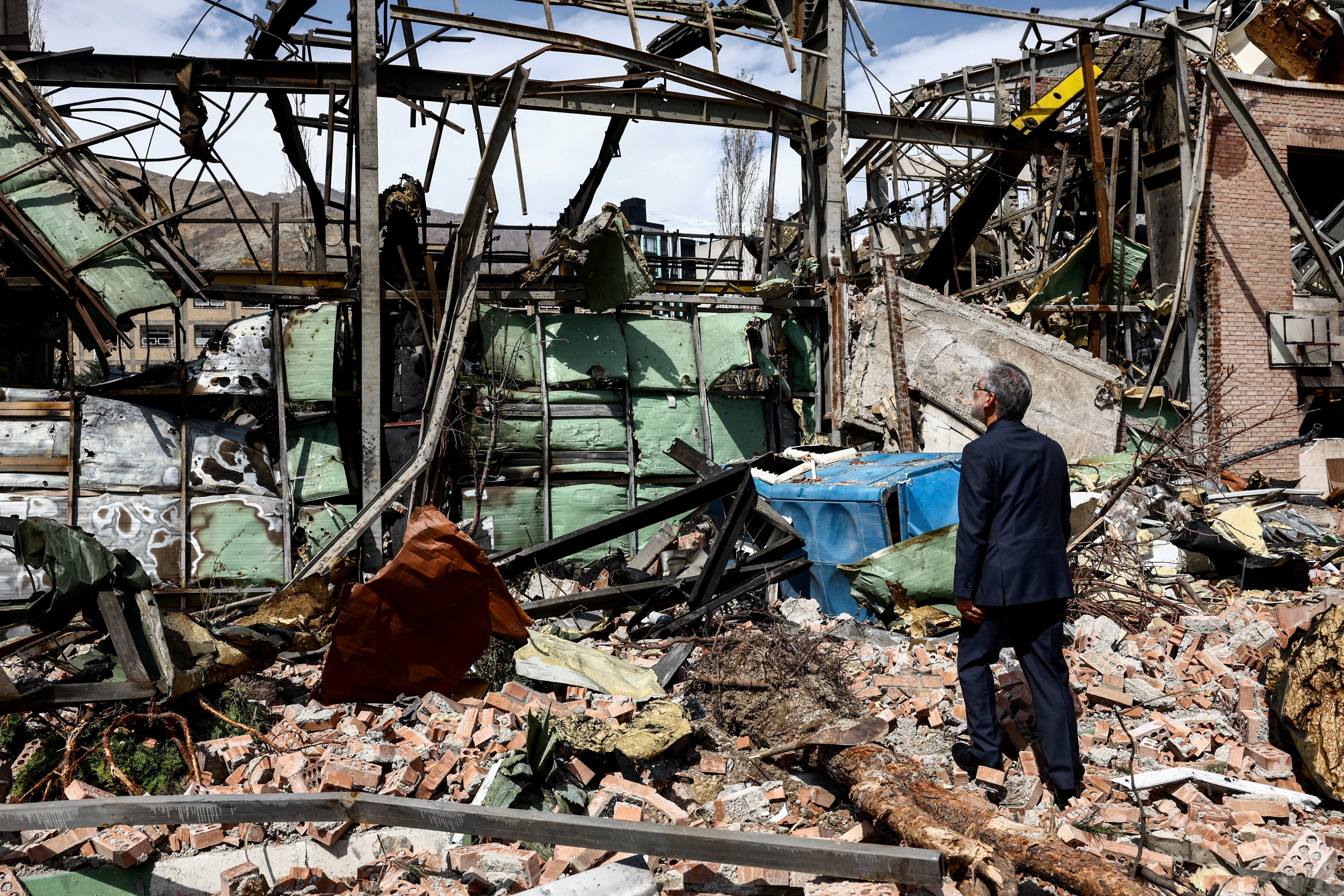 Iran's Minister of Science Hossein Simaee Sarraf inspects the damage at the research building of the Shahid Beheshti University