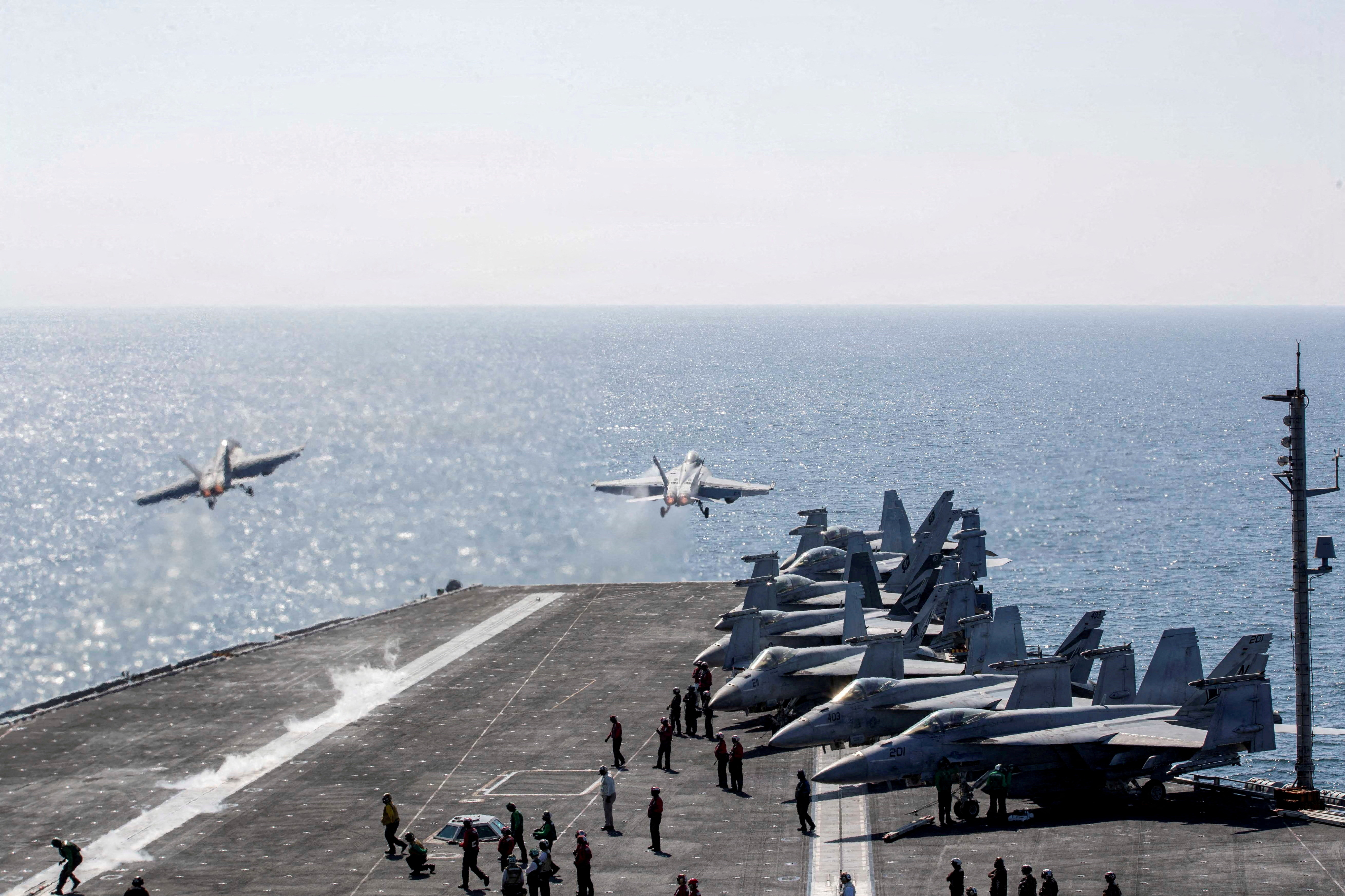 FILE PHOTO: Two F/A-18 Super Hornets launch from the flight deck of the U.S. Navy Nimitz-class aircraft carrier USS Abraham Lincoln in support of the Operation Epic Fury attack on Iran from an undisclosed location March 3, 2026. U.S. Navy/Handout via REUTERS THIS IMAGE HAS BEEN SUPPLIED BY A THIRD PARTY/File Photo