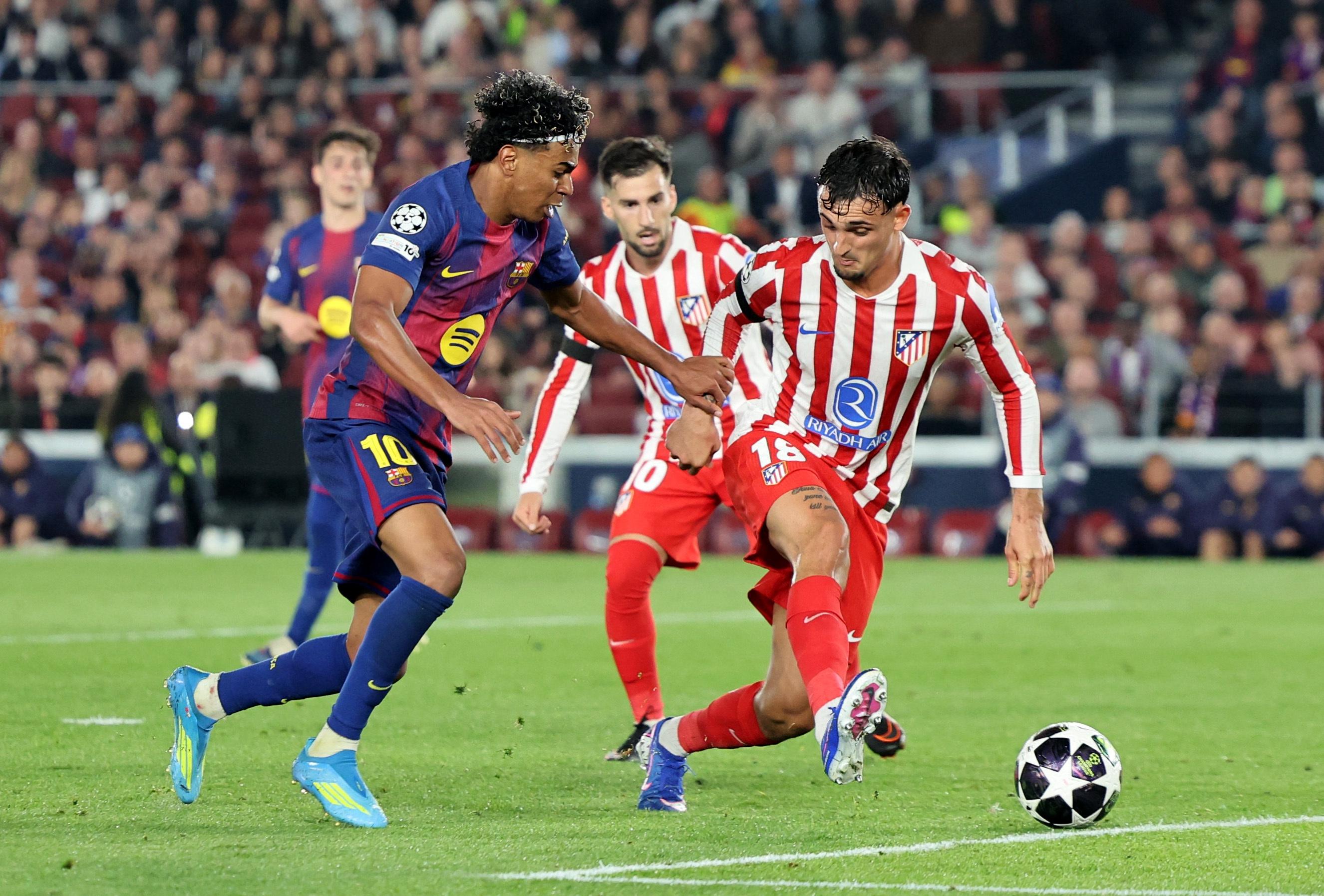 Barcelona's Lamine Yamal in action with Atletico Madrid's Marc Pubill.