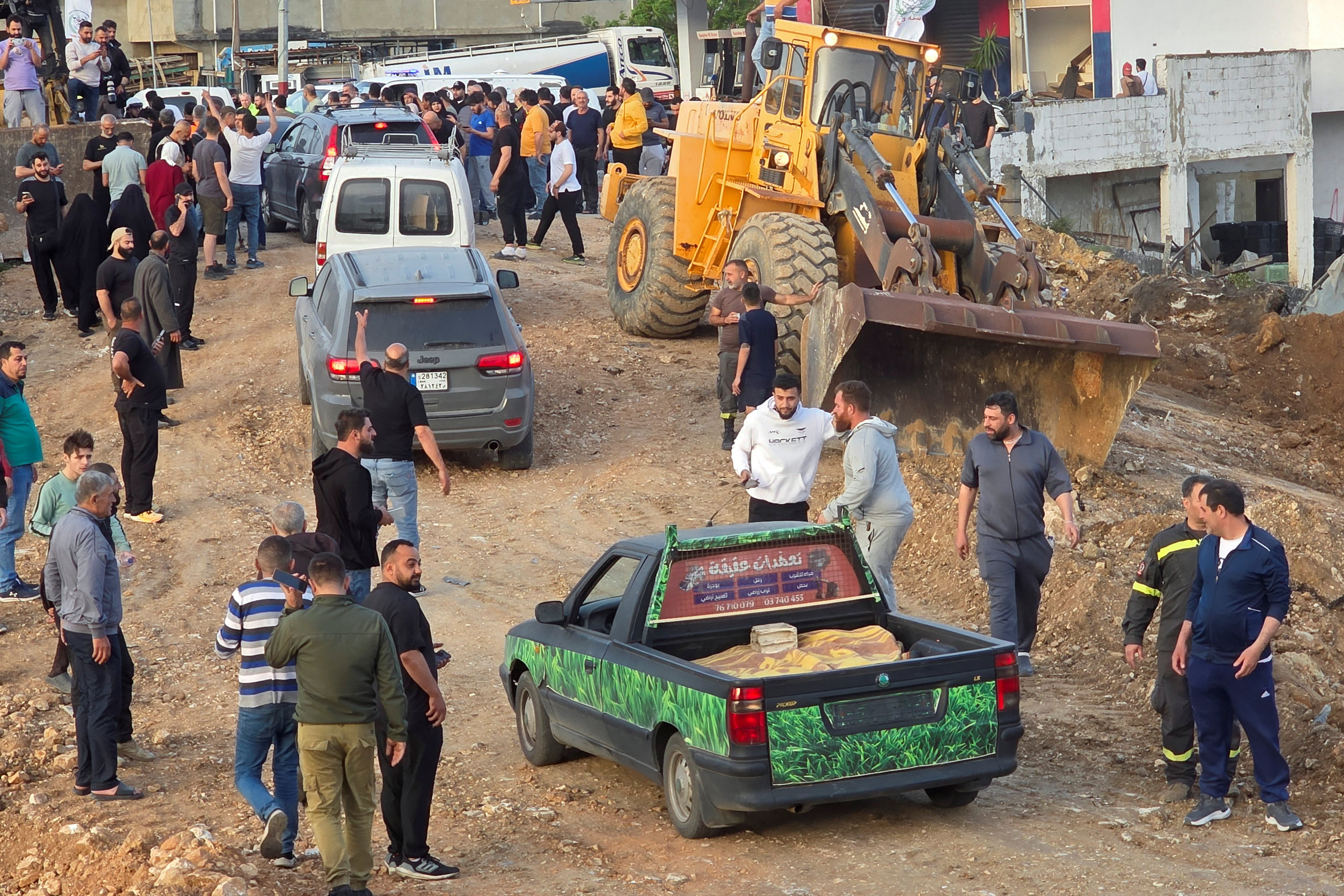 Displaced people make their way back to their homes as they cross the bridge linking southern Lebanon to the rest of the country
