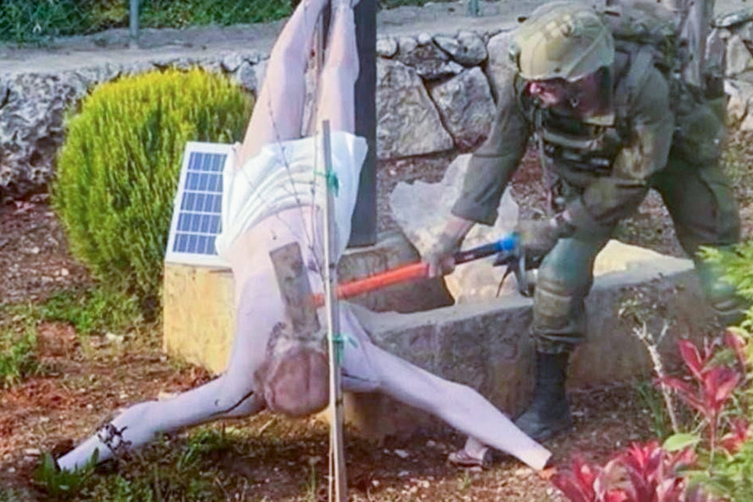 An Israeli soldier damages the head of a statue of Jesus, in Debel, Lebanon, in this still image obtained from social media released on April 19, 2026. Social Media/via REUTERS THIS IMAGE HAS BEEN SUPPLIED BY A THIRD PARTY. NO RESALES. NO ARCHIVES. NEWS USE ONLY. TPX IMAGES OF THE DAY VERIFICATION: - Location is verified as Debel, Lebanon as file imagery of the statue tags Debel as the location - Terrain in background also appears to match hills on topography imagery from Debel - Date shot not confirmed but first posts found online April 19 - Israel Defense Forces posted on X saying it was investigating the incident and would work to restore the statue to its place