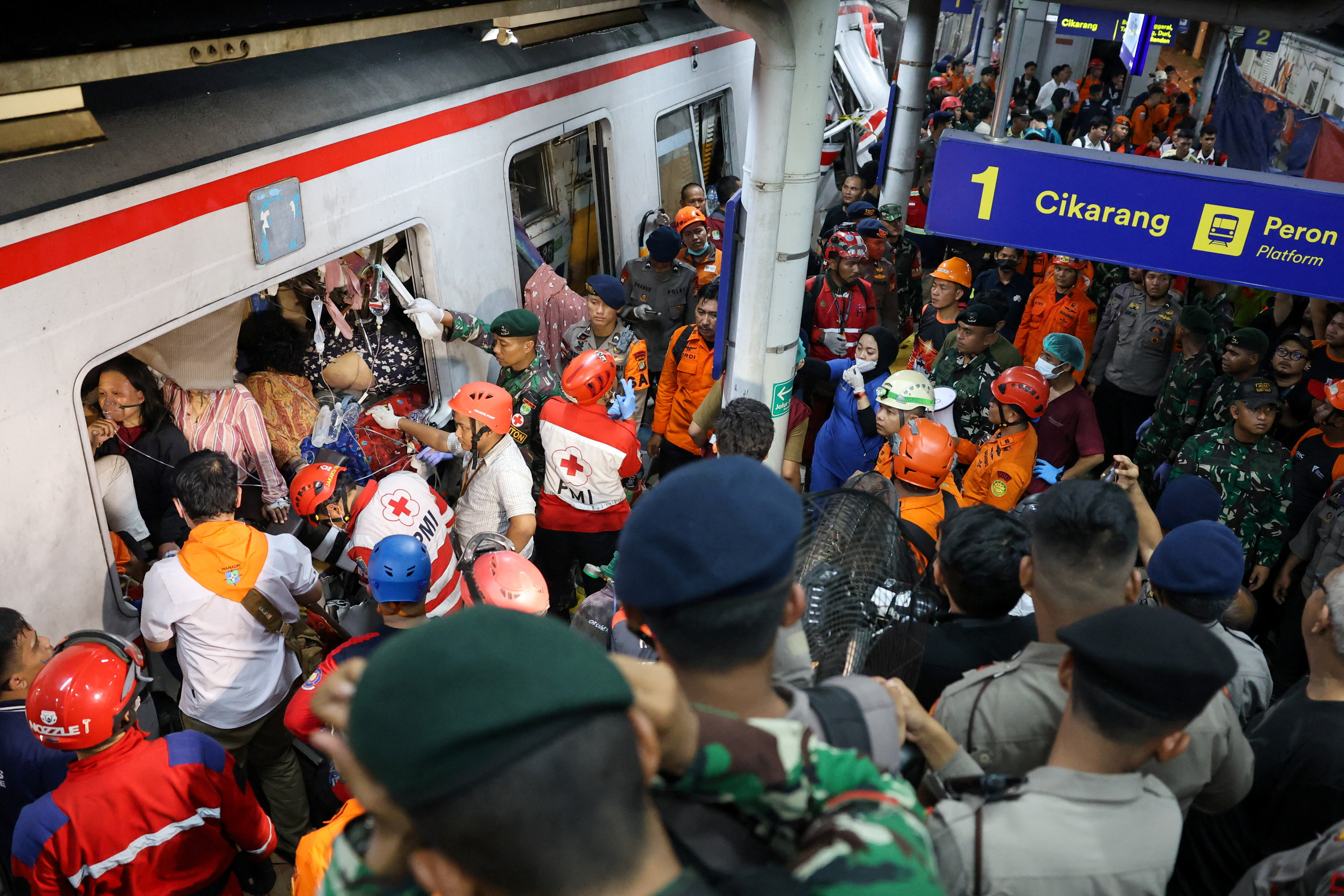 Emergency personnel rescue passengers trapped in the damaged train, after two trains collided late on Monday in Bekasi, West Java province, Indonesia, April 28, 2026. REUTERS/Ajeng Dinar Ulfiana