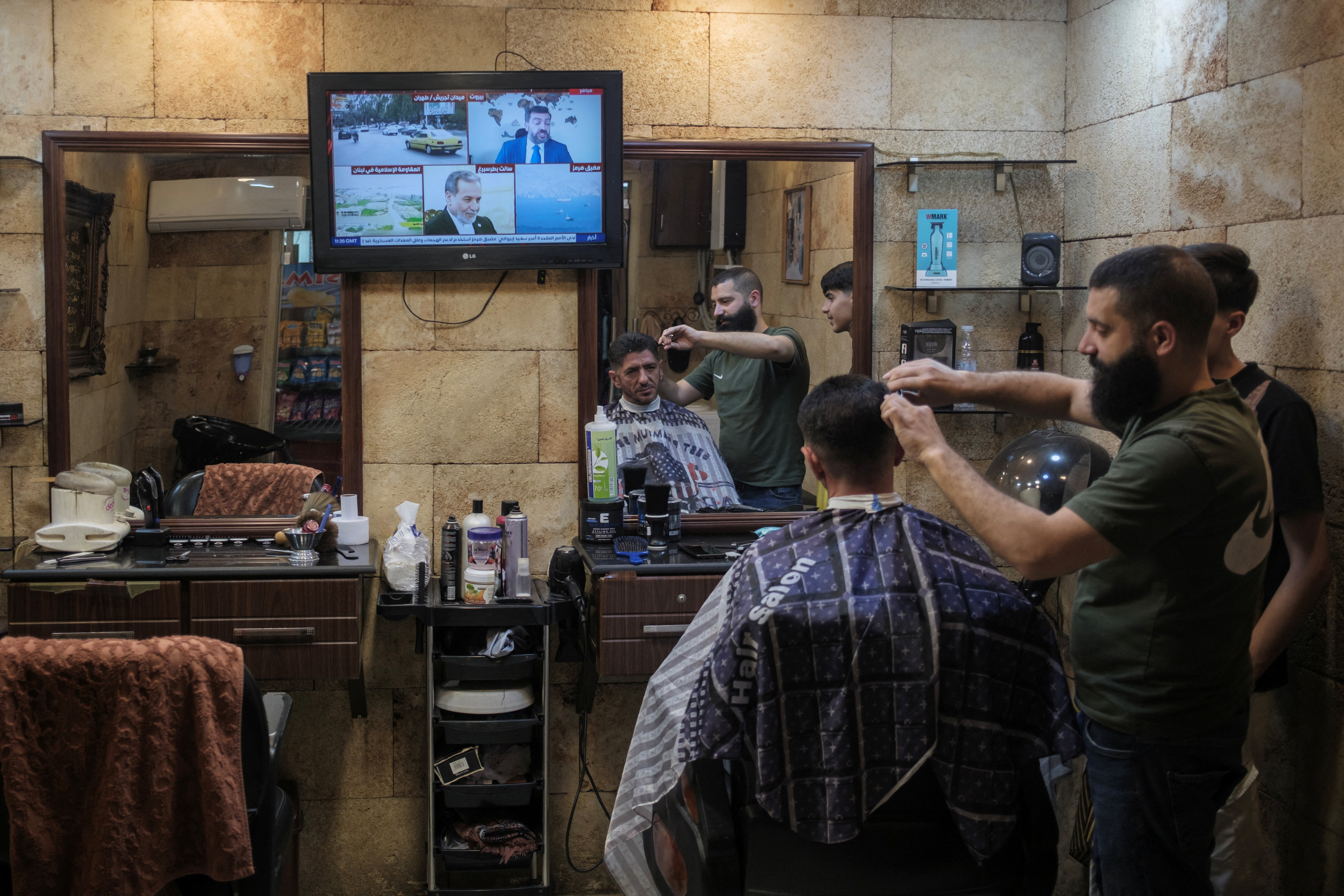 A man gets a haircut in old market, amid a temporary ceasefire between Lebanon and Israel