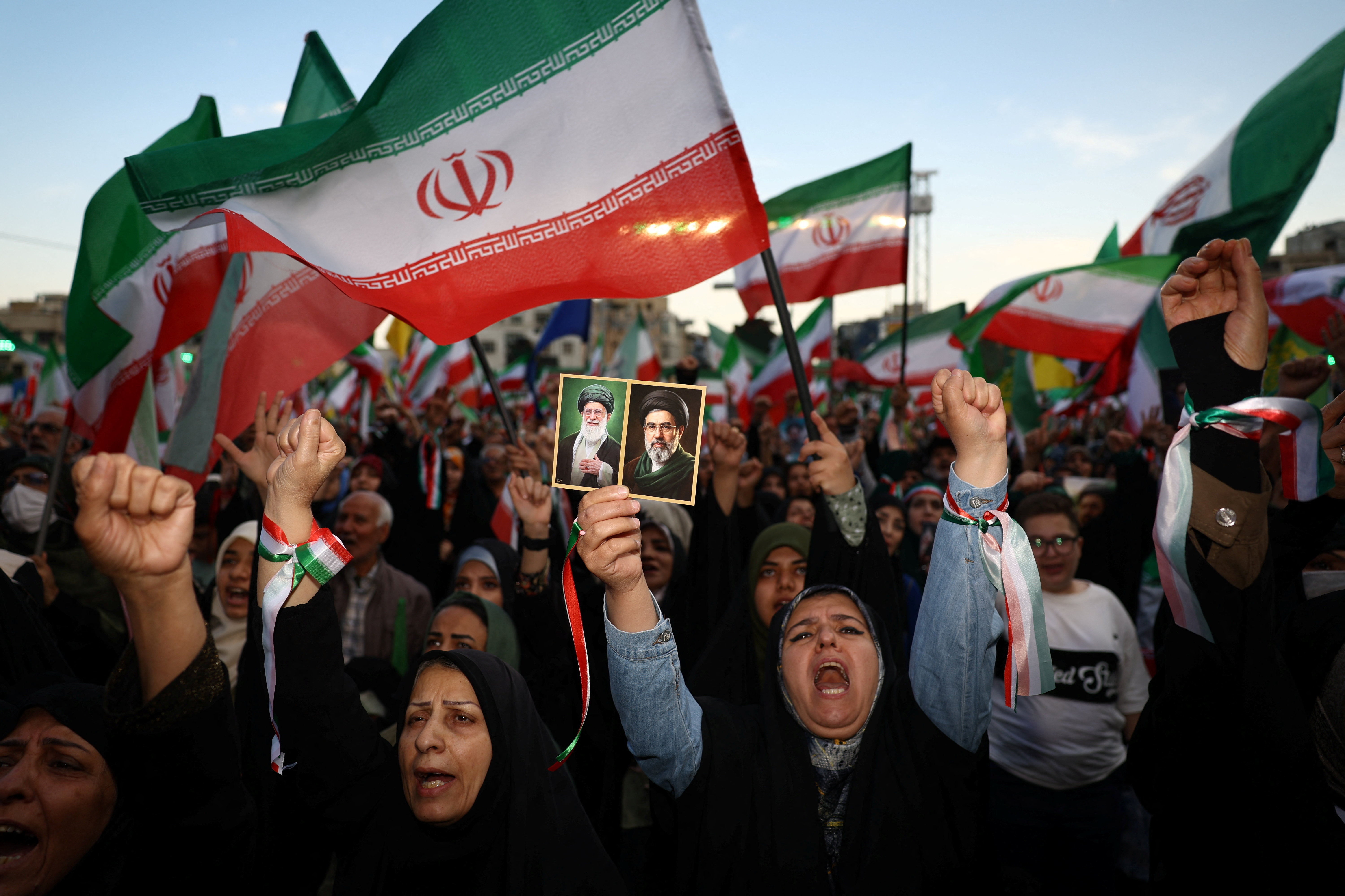 People chant slogans during a rally in Tehran, Iran