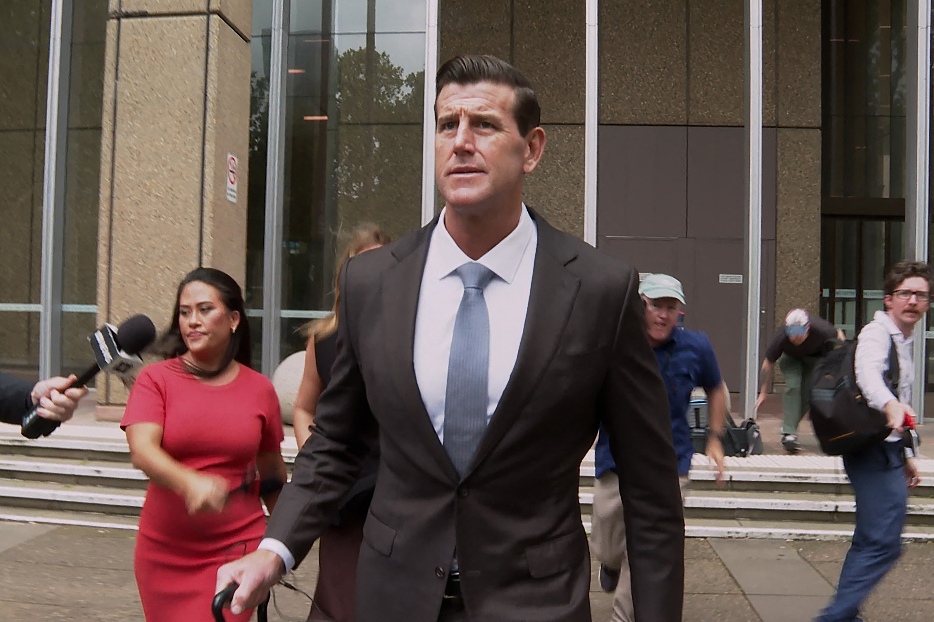Ben Roberts-Smith wearing a suit and leaving court in Sydney