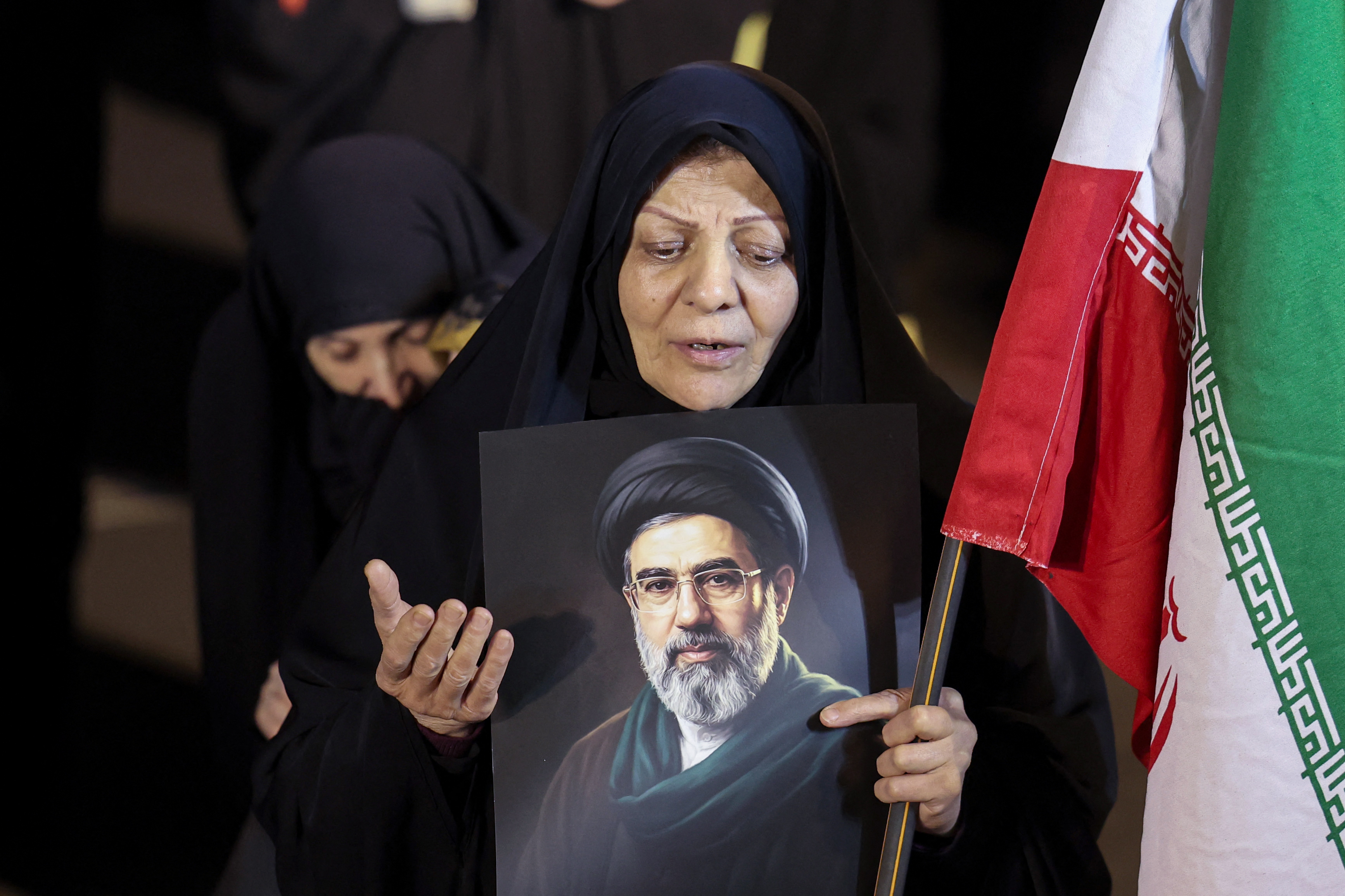 A woman holds a portrait of Iran's supreme leader Mojtaba Khamenei as people march in support of the Iranian armed forces in central Tehran on March 25, 2026. President Donald Trump is ready to "unleash hell" if Iran doesn't accept a deal to end the Middle East war, the White House warned on March 25, adding that talks continued despite Tehran reportedly rejecting a proposed US peace plan. [Photo by AFP]