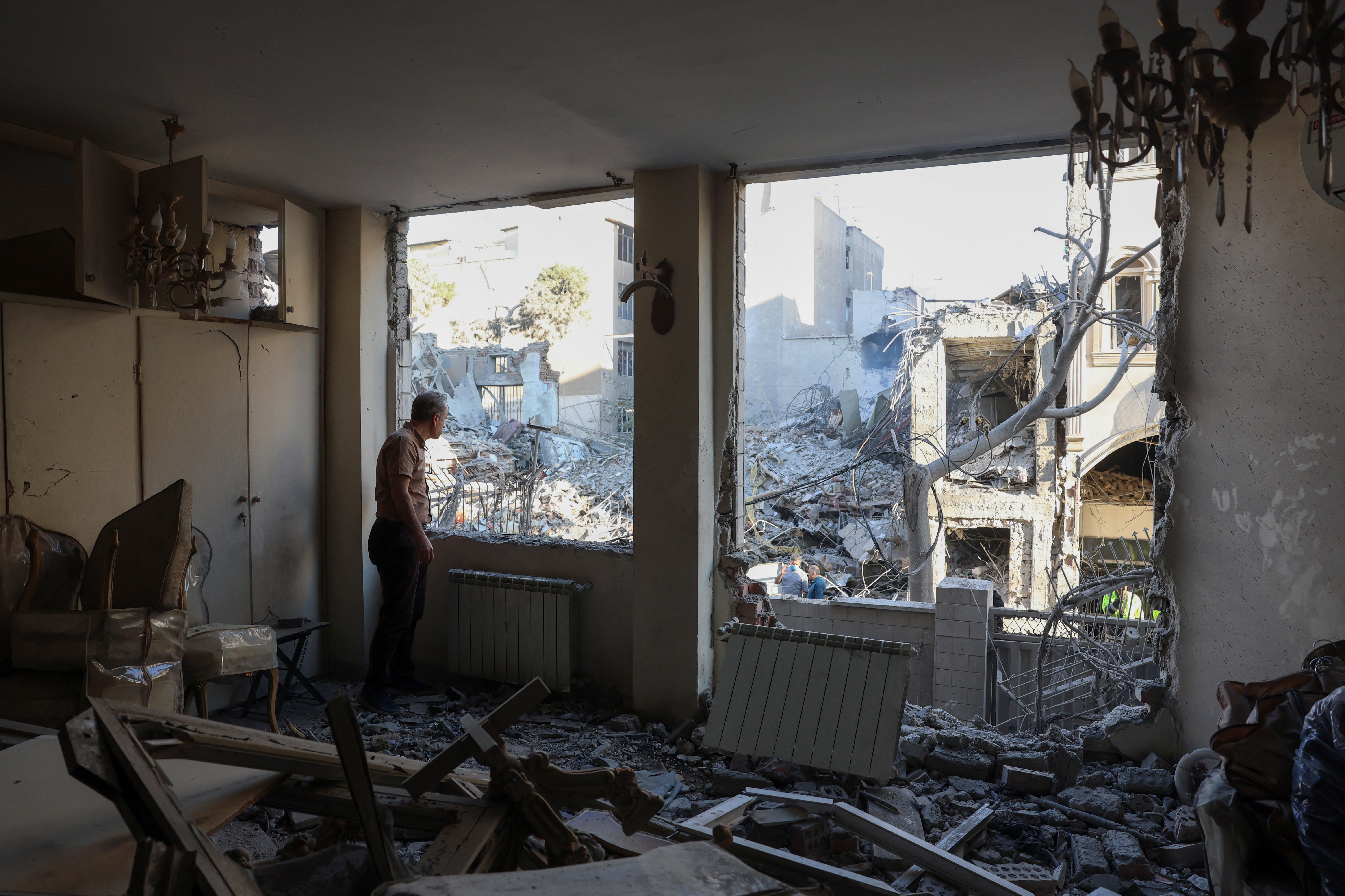 An Iranian resident looks out the window