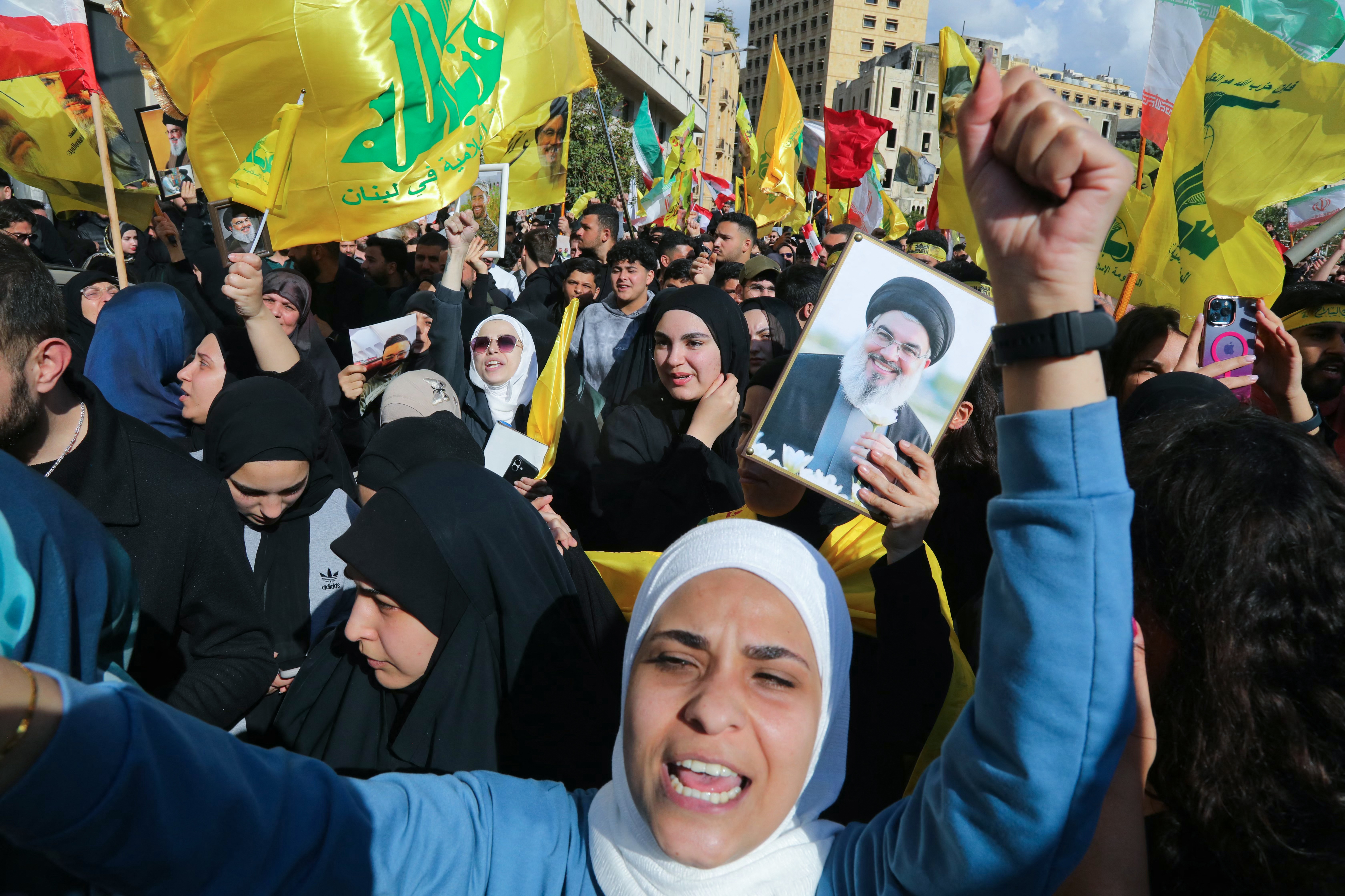 Hezbollah supporters, some waving the party flag and holding up an image of slain Hezbollah leader Hasan Nasrallah, demonstrate near the Governmental Palace to protest the Lebanese authorities' decision to engage in direct negotiations with Israel to end the ongoing war, in downtown Beirut on April 11, 2026. 