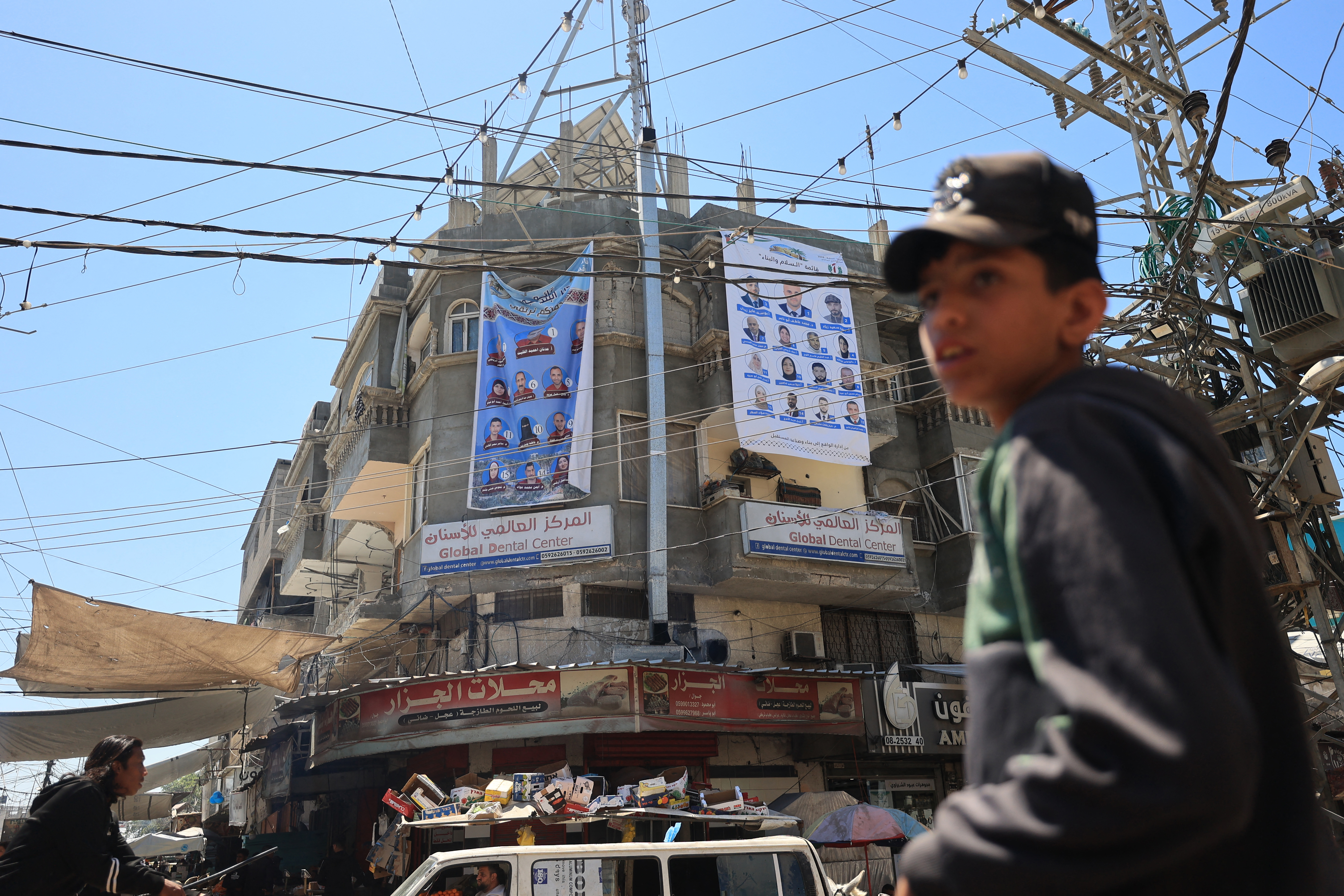 Election campaign banners showing candidates for the upcoming municipal elections hang on a building in Deir el-Balah in the central Gaza Strip
