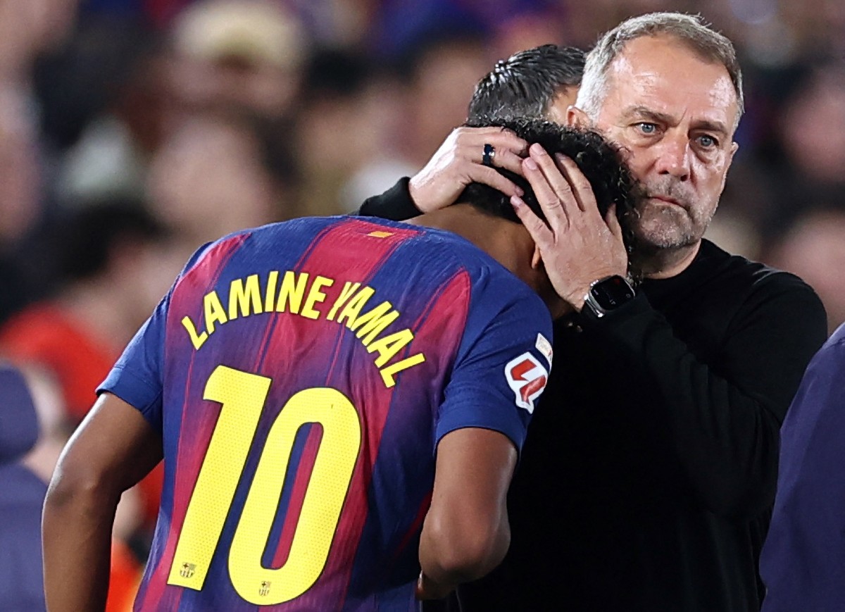 Barcelona's German coach Hans-Dieter Flick hugs Barcelona's Spanish forward #10 Lamine Yamal