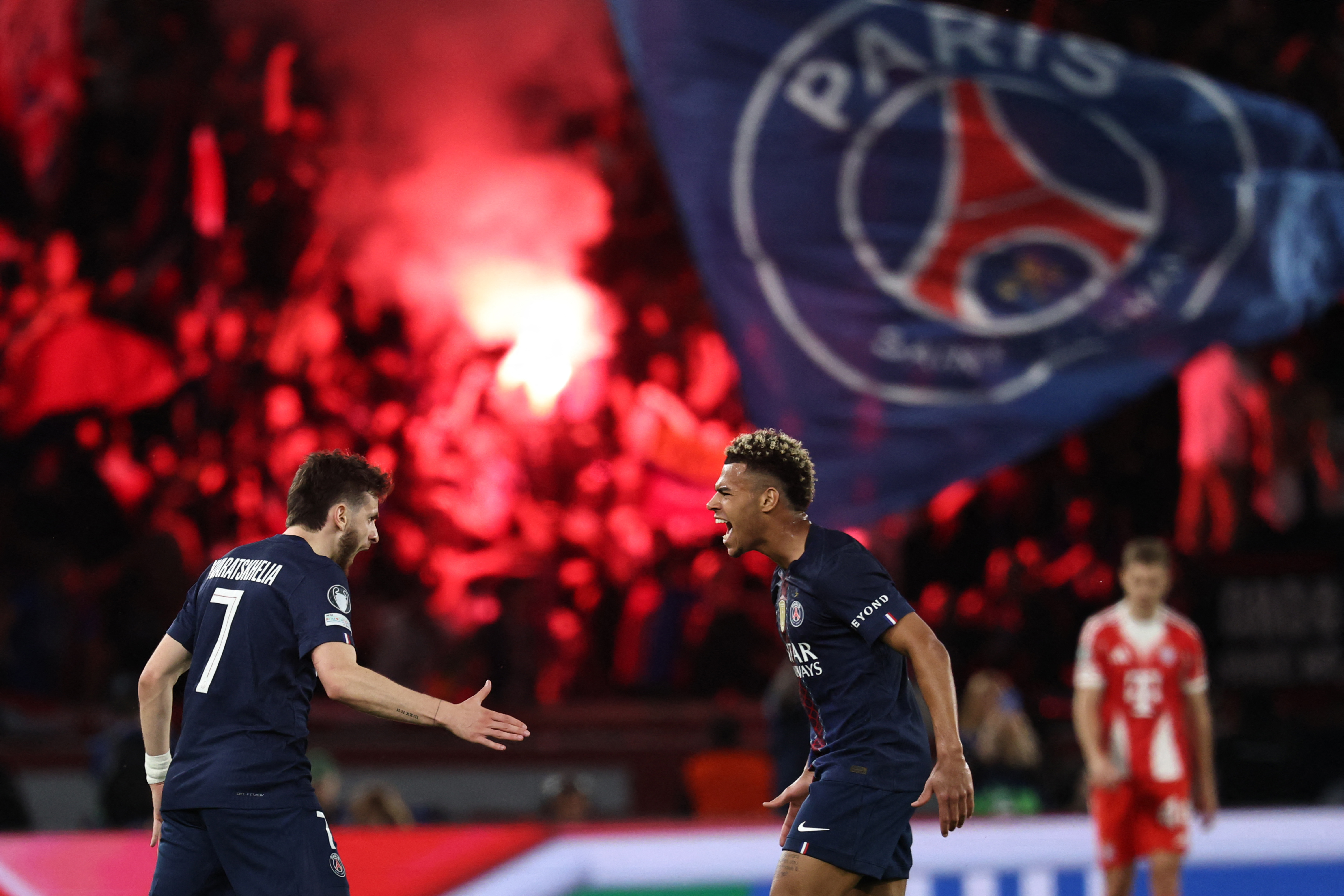 Paris Saint-Germain's Georgian forward #07 Khvicha Kvaratskhelia (L) celebrates with Paris Saint-Germain's French midfielder #14 Desire Doue after scoring his team's first goal.