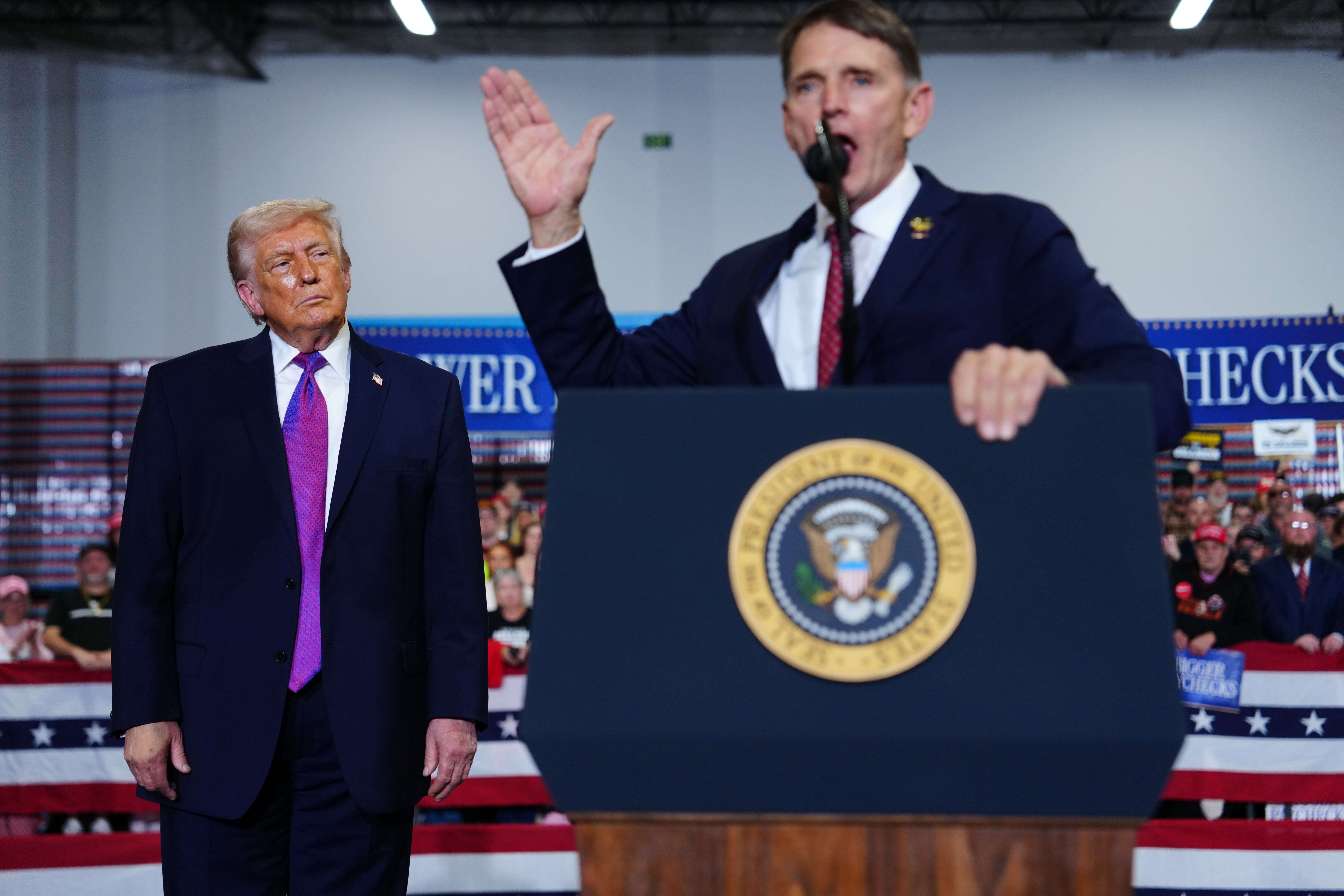 President Donald Trump listens as congressional candidate Ed Gallrein speaks at Verst Logistics Wednesday, March 11, 2026, in Hebron, Ky. (AP Photo/Julia Demaree Nikhinson)