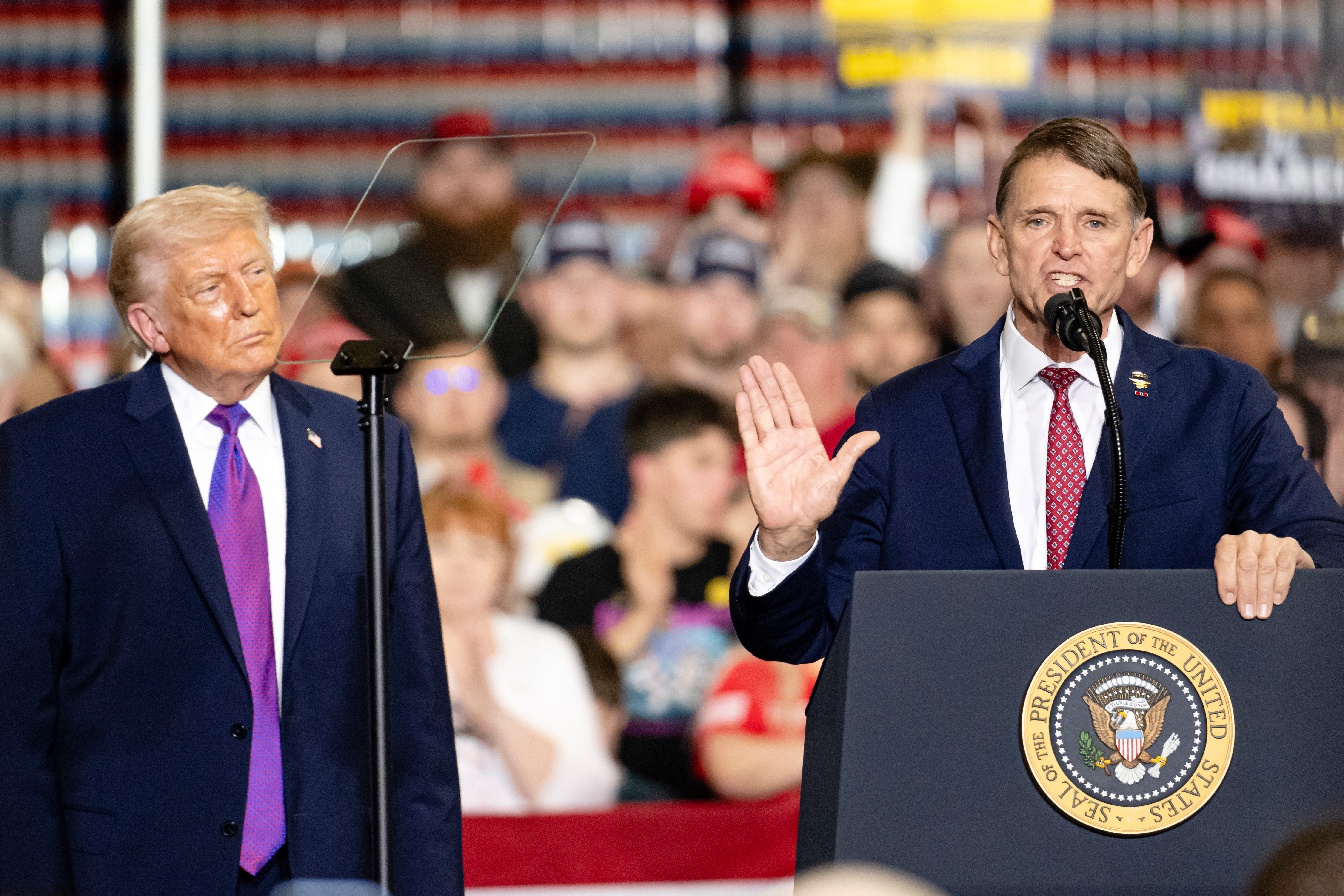 Congressional candidate Ed Gallrein speaks as President Donald Trump listens at Verst Logistics Contract Packaging Facility Wednesday, March 11, 2026, in Hebron, Ky. (AP Photo/Jon Cherry)