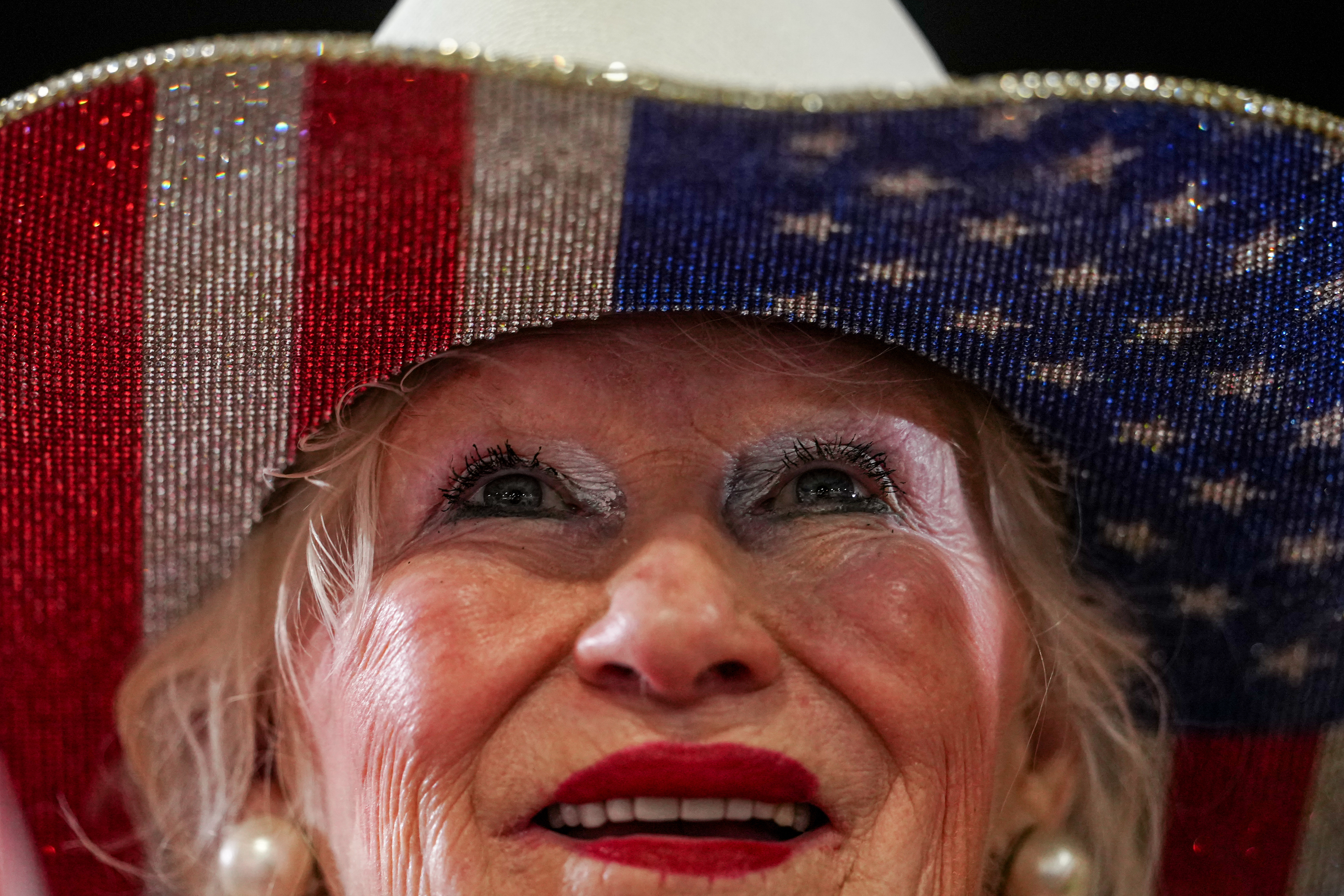 A woman listens to President Donald Trump speak at Verst Logistics, Wednesday, March 11, 2026, in Hebron, Ky. (AP Photo/Julia Demaree Nikhinson)