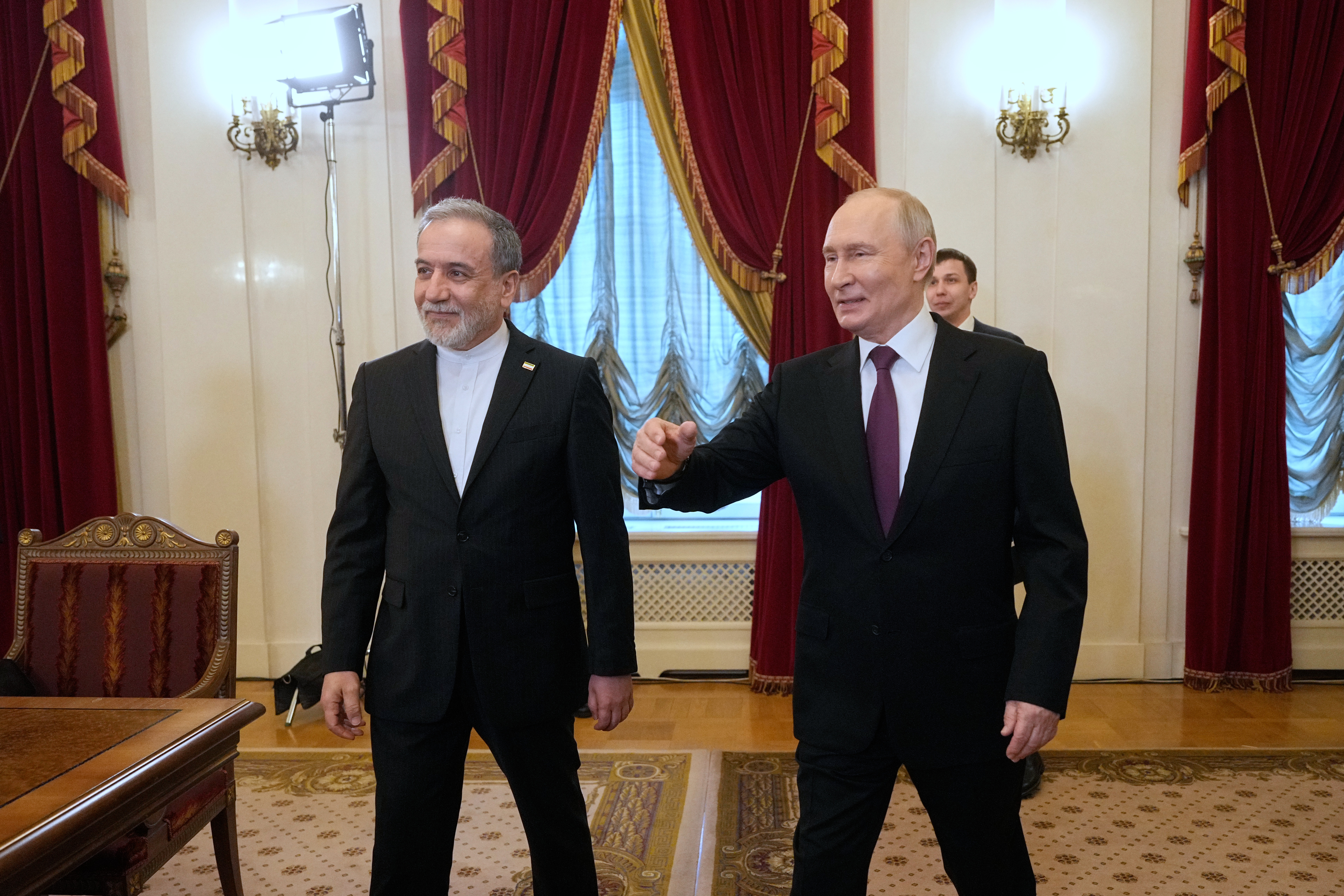 Russian President Vladimir Putin, right, and Iranian Foreign Minister Abbas Araghchi walk to attend the talks at the Boris Yeltsin Presidential Library, in St. Petersburg, Russia, Monday, April 27, 2026. (AP Photo/Dmitri Lovetsky, Pool)