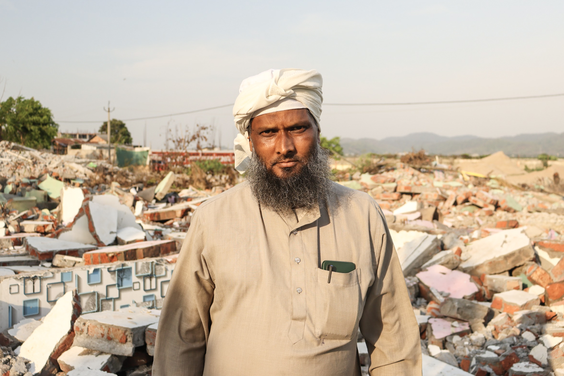 Akram Ali stood by the ruins of his four-room home under scorching heat.