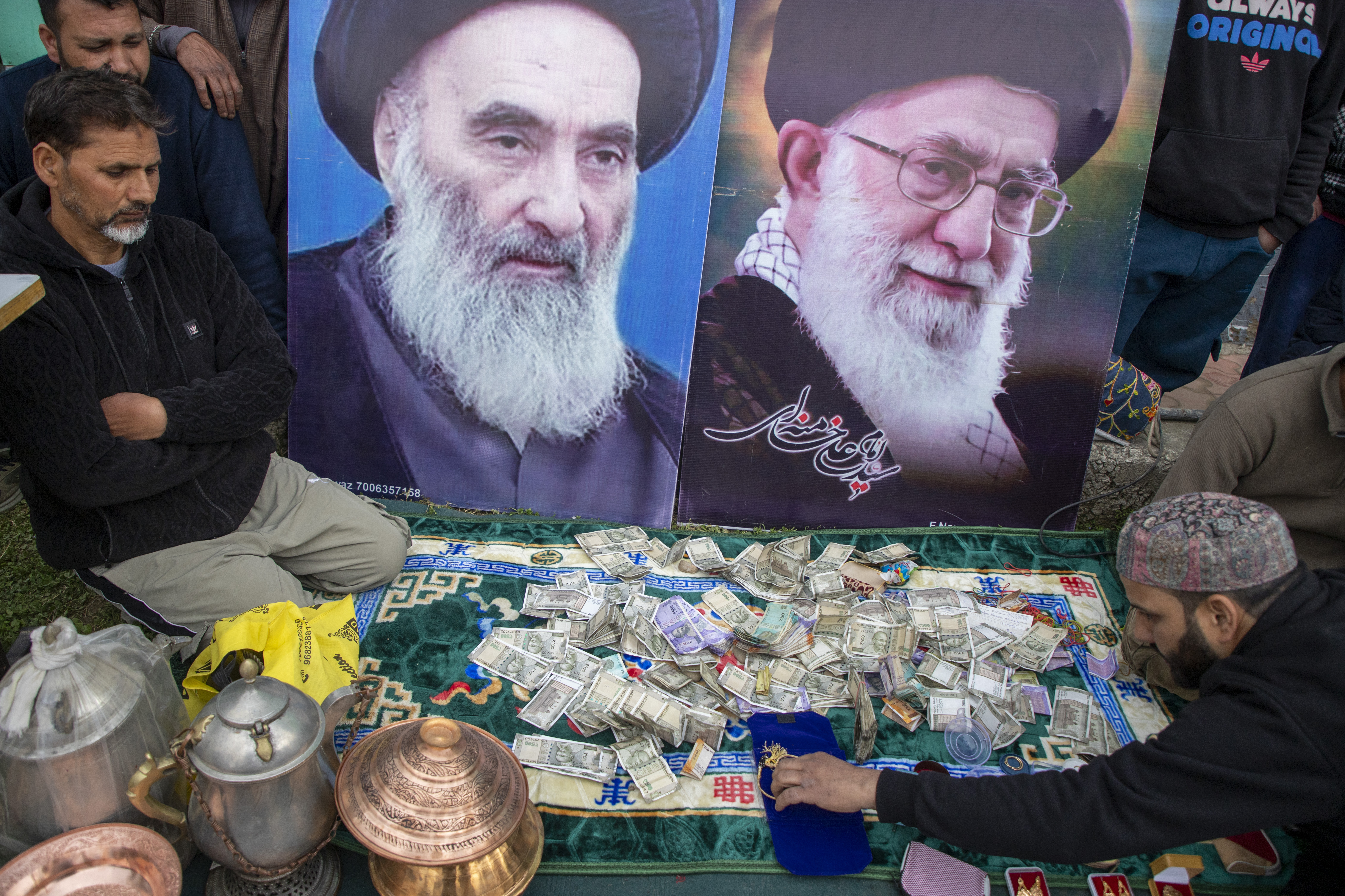 Cash donated for Iran at a collection drive in Indian-administered Kashmir [Junaid Bhat/ Al Jazeera]