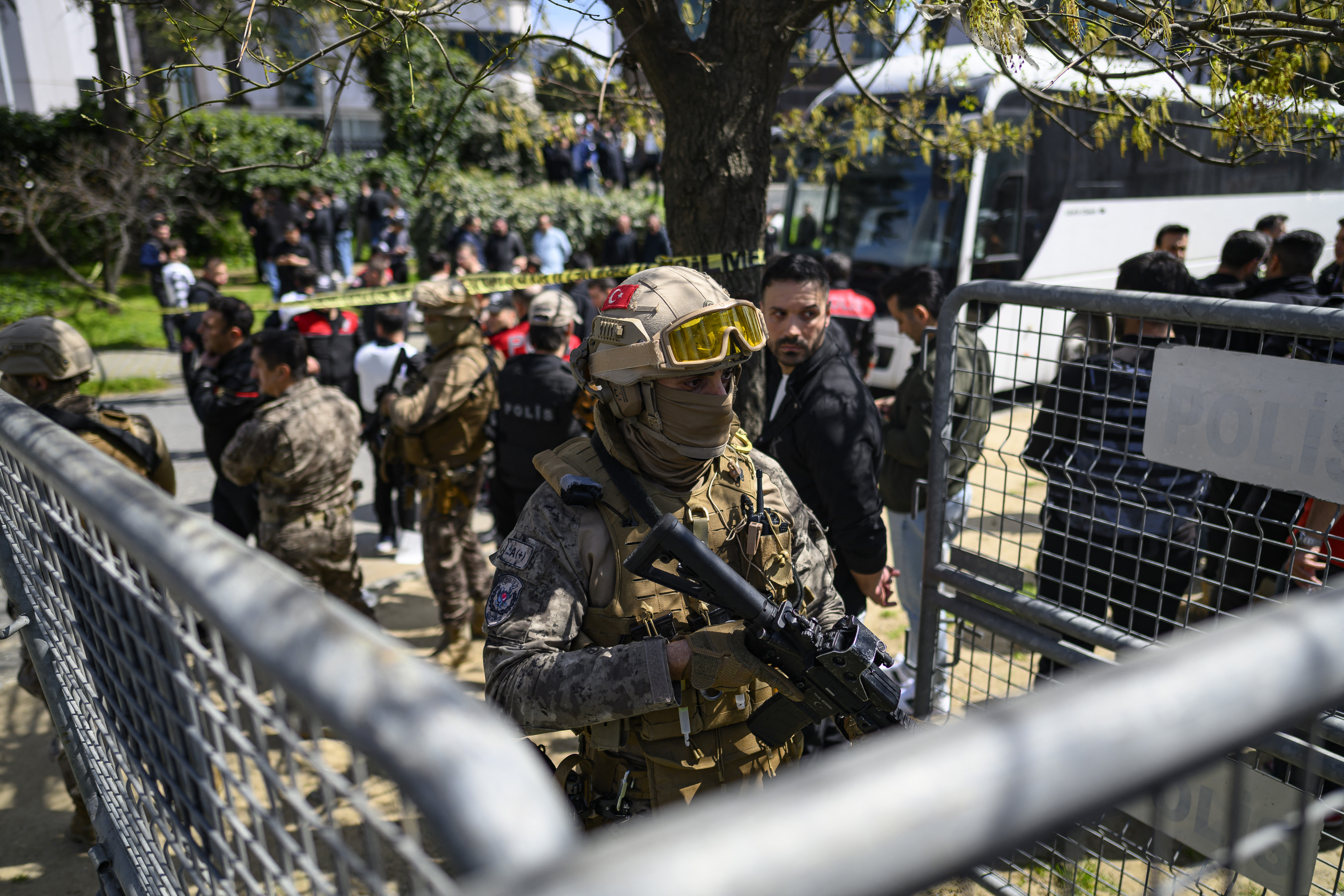 TOPSHOT - A police official stands alert near The Israeli Consulate in Istanbul on April 7, 2026, following a shootout between gunmen and police.