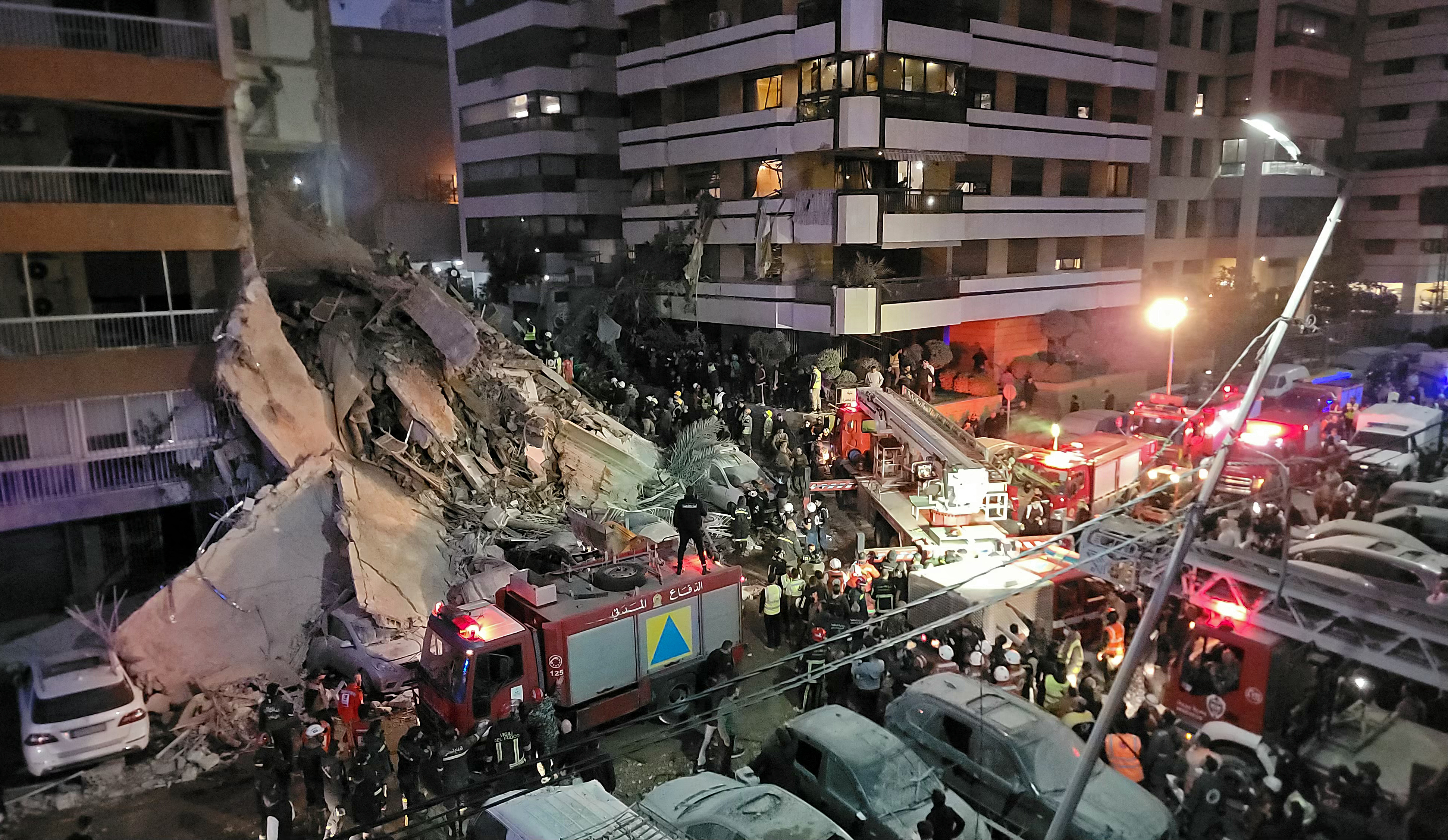 First responders and residents gather at the site of an Israeli airstrike in Beirut's Tallet al-Khayyat neighbourhood, on April 8, 2026.