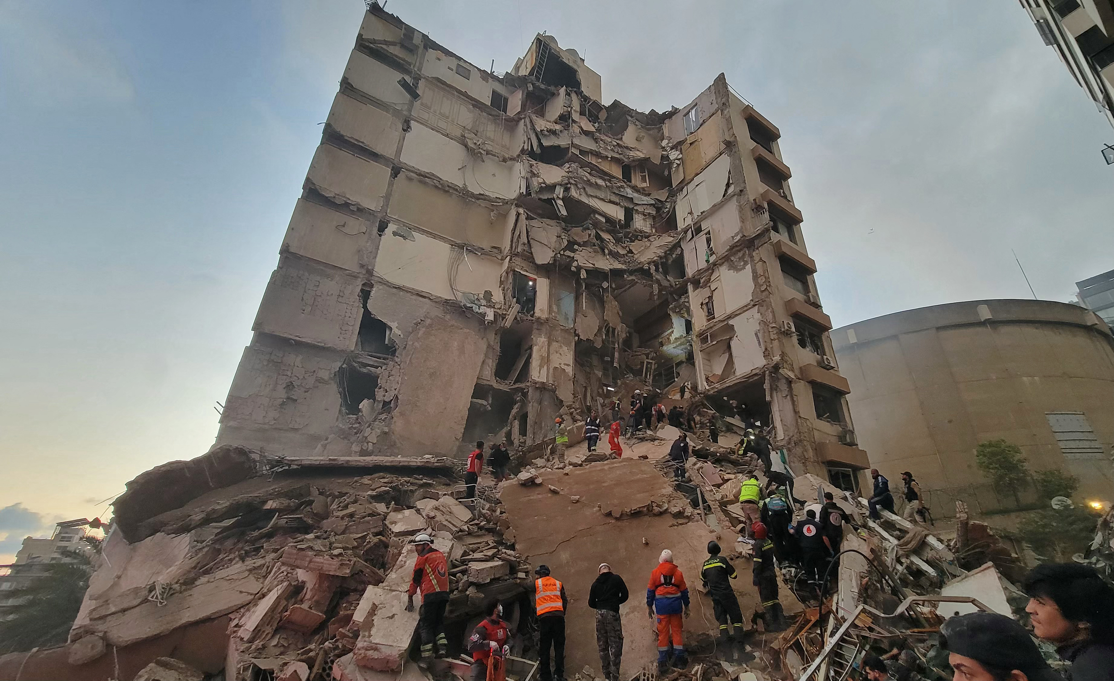 First responders and residents gather at the site of an Israeli airstrike in Beirut's Tallet al-Khayyat neighbourhood, on April 8, 2026.