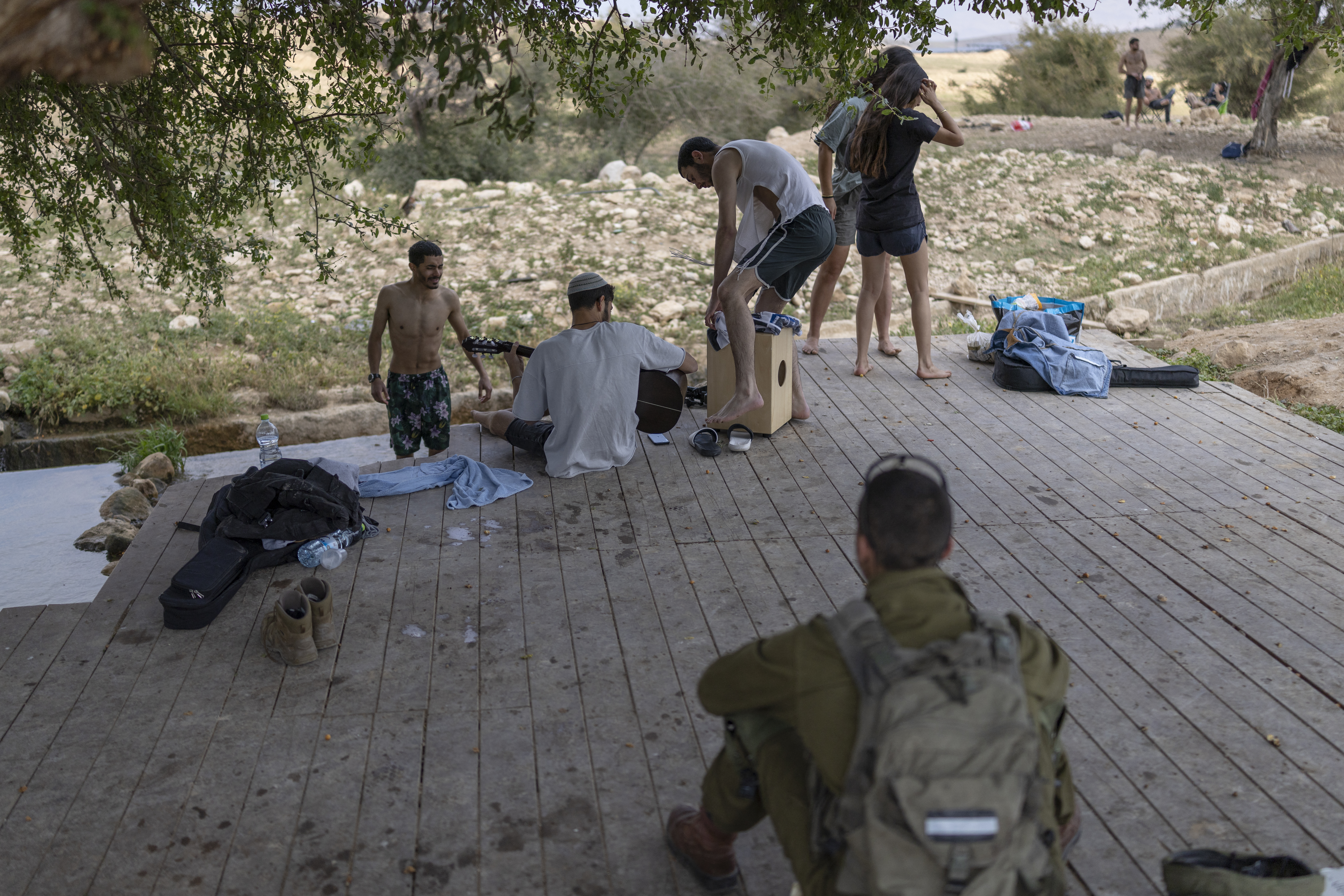 TOPSHOT - Israeli settlers gather at the Israeli-occupied West Bank village of Ras Ein al-Auja on April on April 9, 2026.