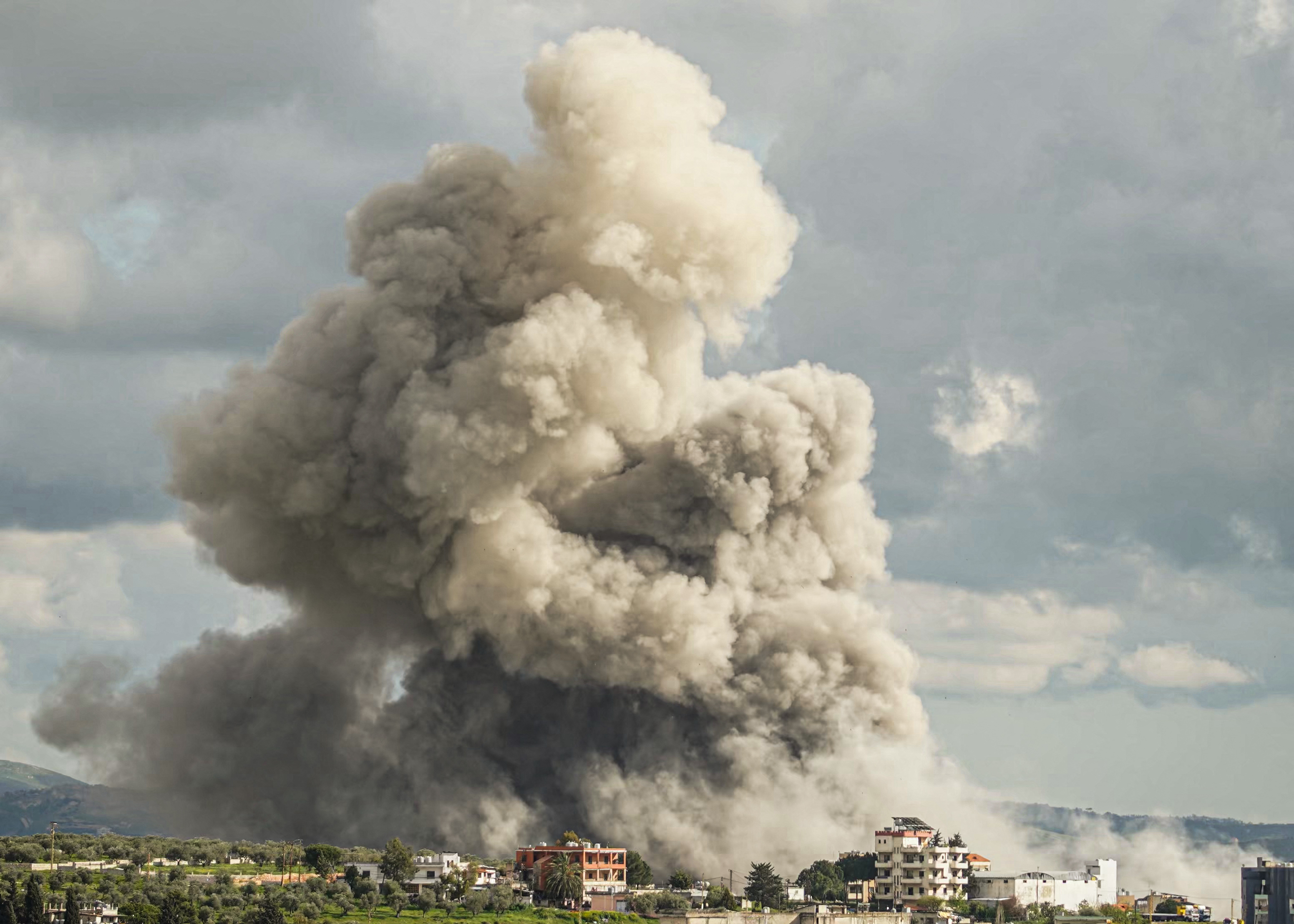 TOPSHOT - Smoke rises from the site of an Israeli airstrike that targeted an area in the southern Lebanese city of Nabatieh on April 12, 2026.