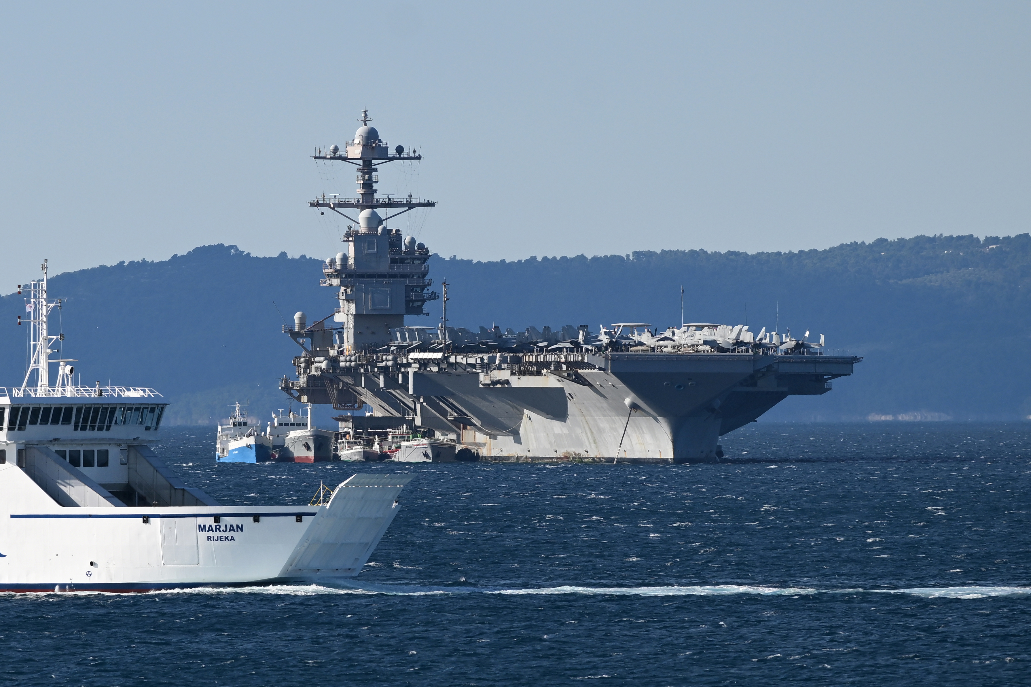 epa12858426 The US Navy aircraft carrier USS Gerald R. Ford (CVN-78) sits anchored in Split, Croatia, 29 March 2026. The ship arrived for repairs following a non-combat fire during operations in the Red Sea. The world's largest carrier, which recently supported Operation Epic Fury, transitioned to the NATO-allied port after a March 12 laundry room fire injured three sailors and damaged sleeping quarters. The vessel remains a centerpiece of US naval power, housing over 5,000 crew members and 75 military aircraft. EPA/STRINGER