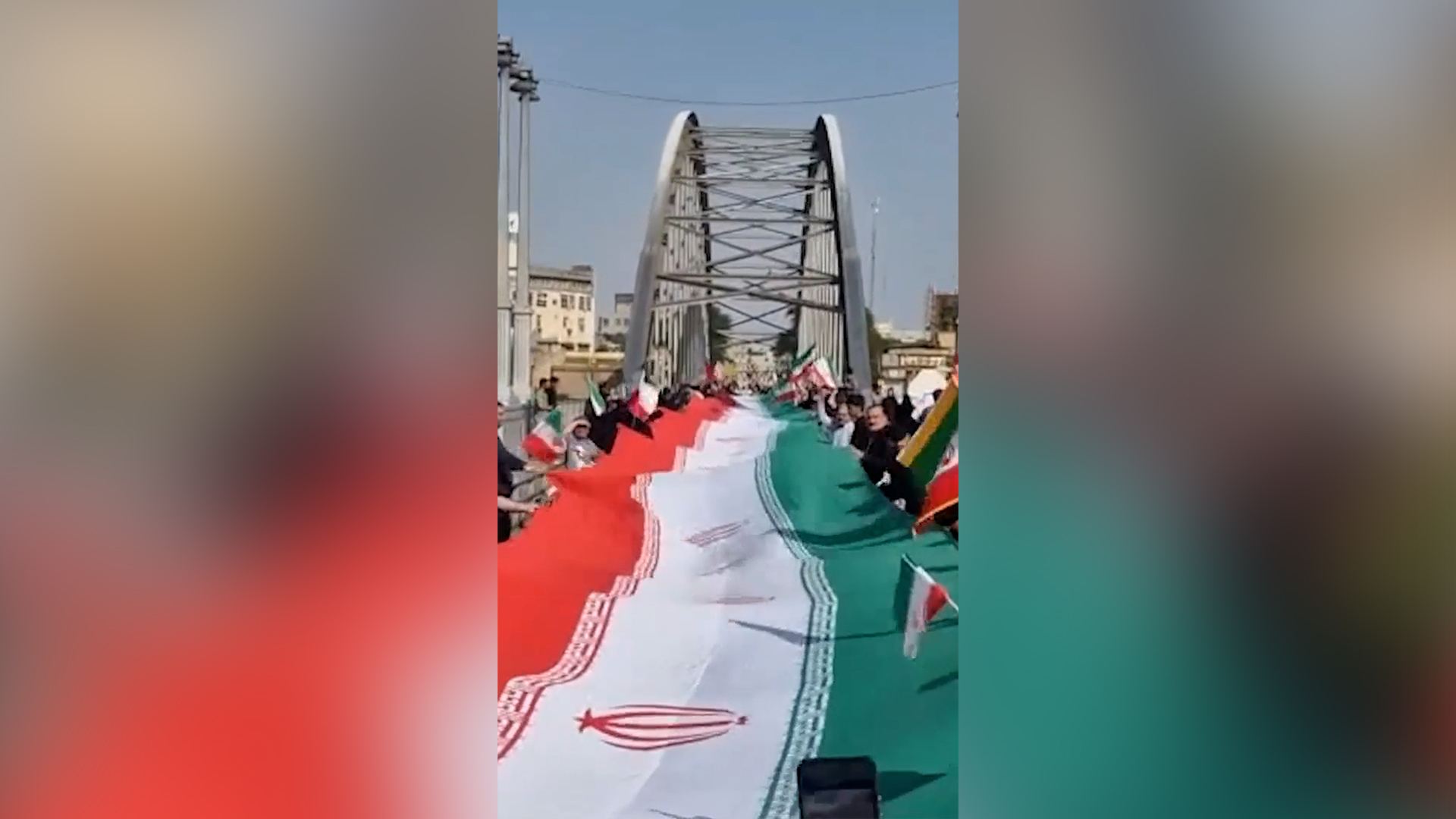 Iranians form a human chain across a bridge in Dezful, Iran in footage released by FARS on April 7, 2026. [Screenshot via FARS]