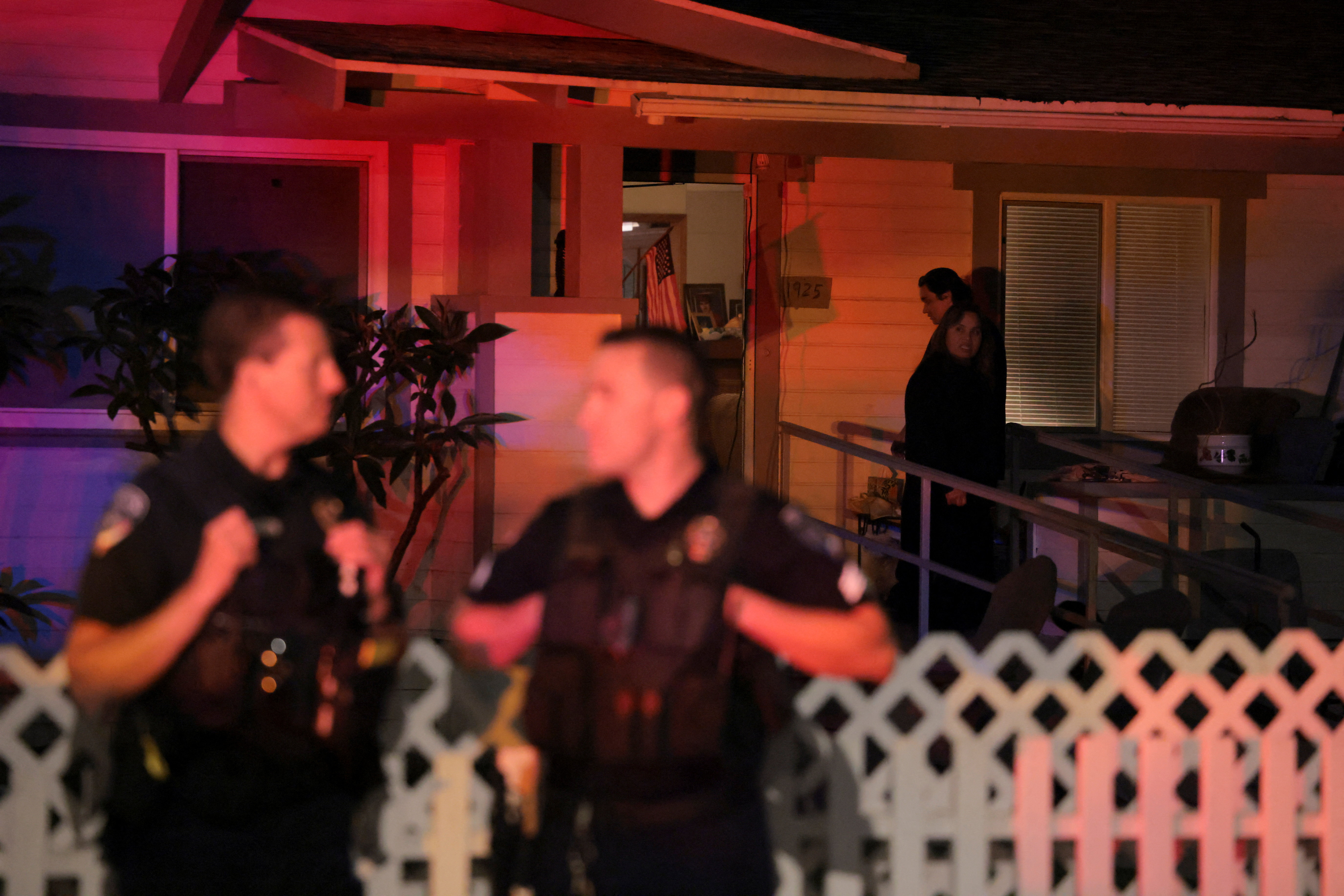 People in the neighbourhood look on as police stand on the corner outside the residence associated with Cole Tomas Allen, the suspect in the shooting incident at the annual White House Correspondents' Association dinner in Washington, D.C., in Torrance, California, U.S., April 25, 2026. REUTERS/Daniel Cole