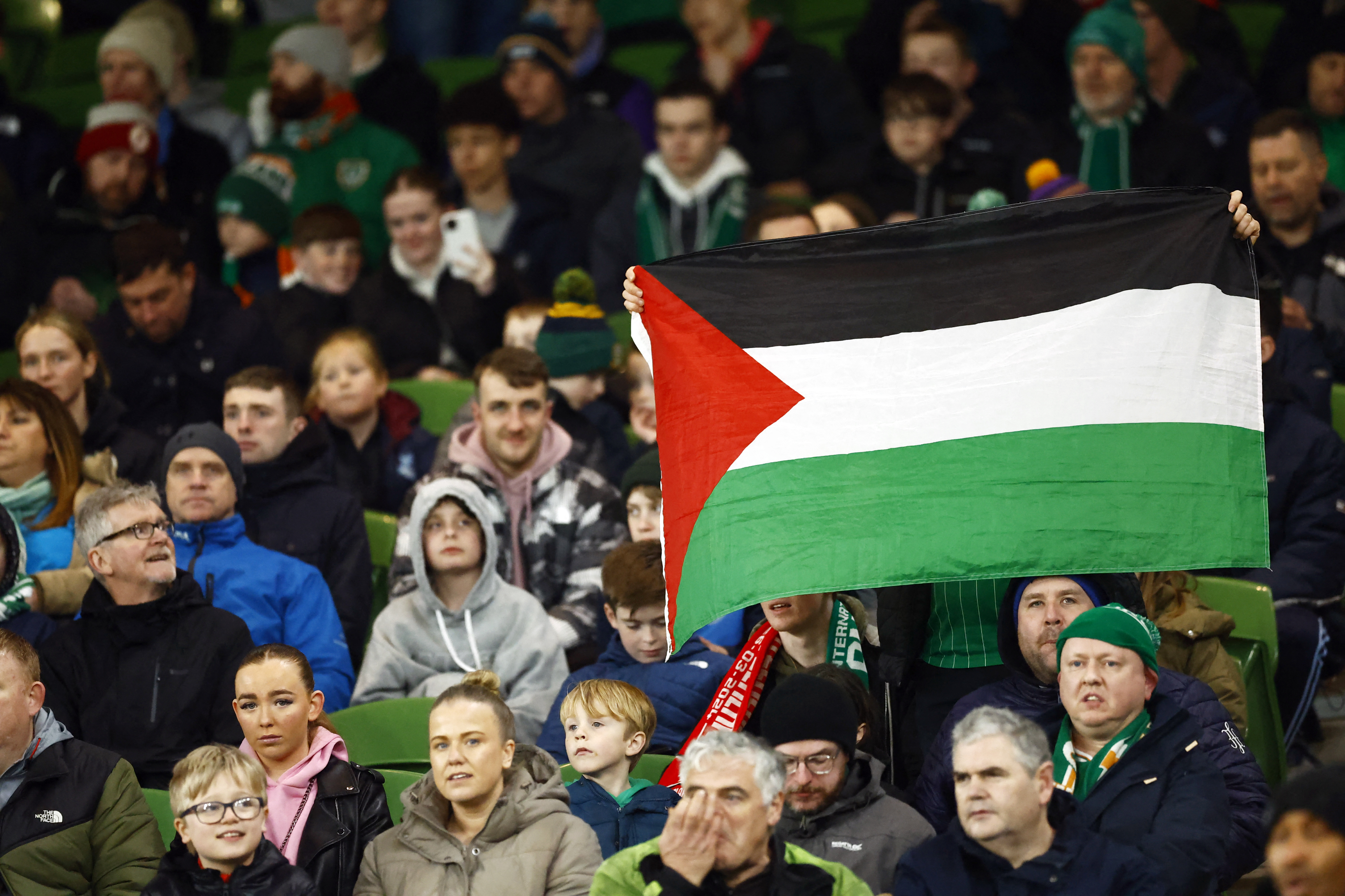 Ireland fans display the flag of Palestine in the stands before the match