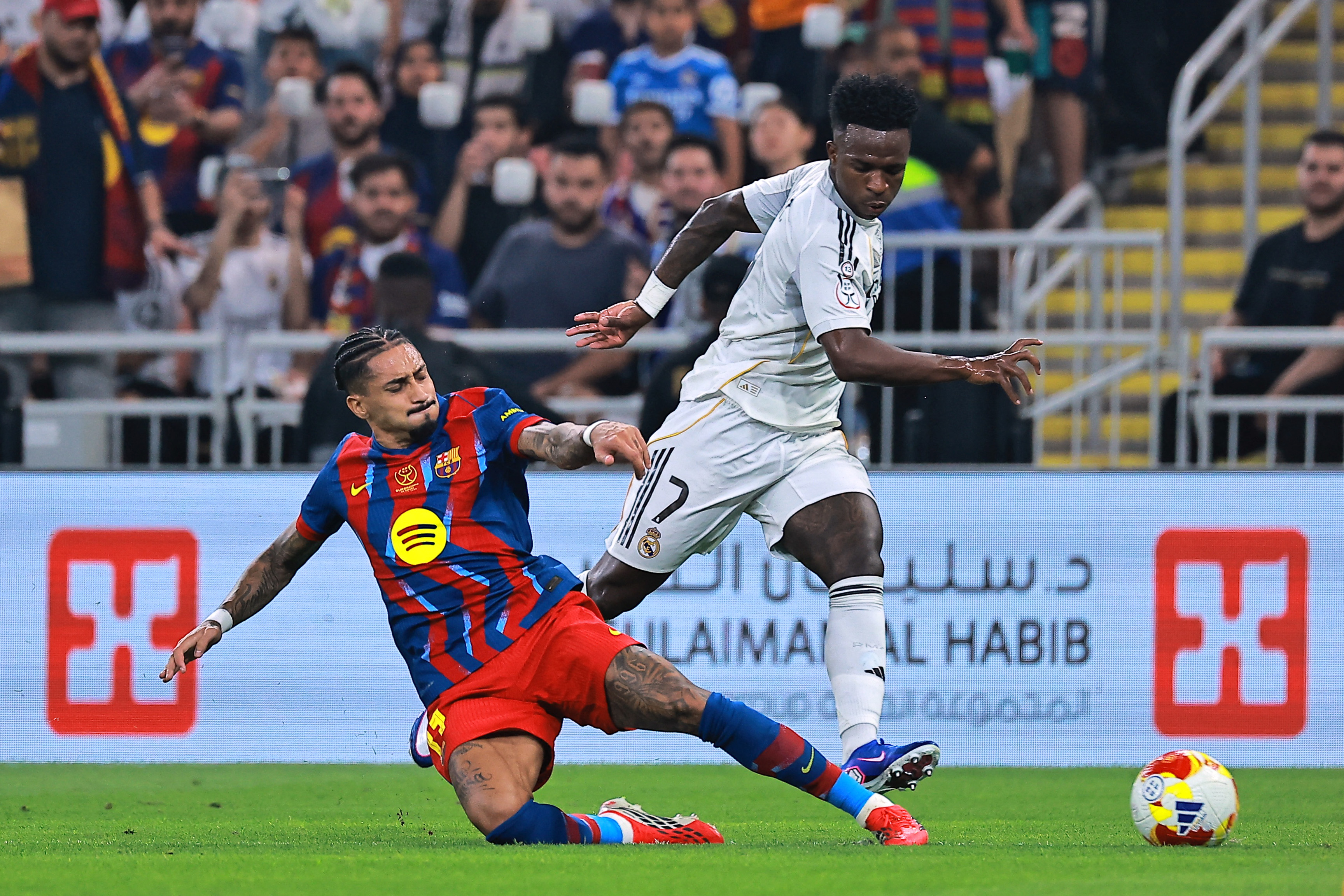 Barcelona's Raphinha in action with Real Madrid's Vinicius Junior in the last El Clasico