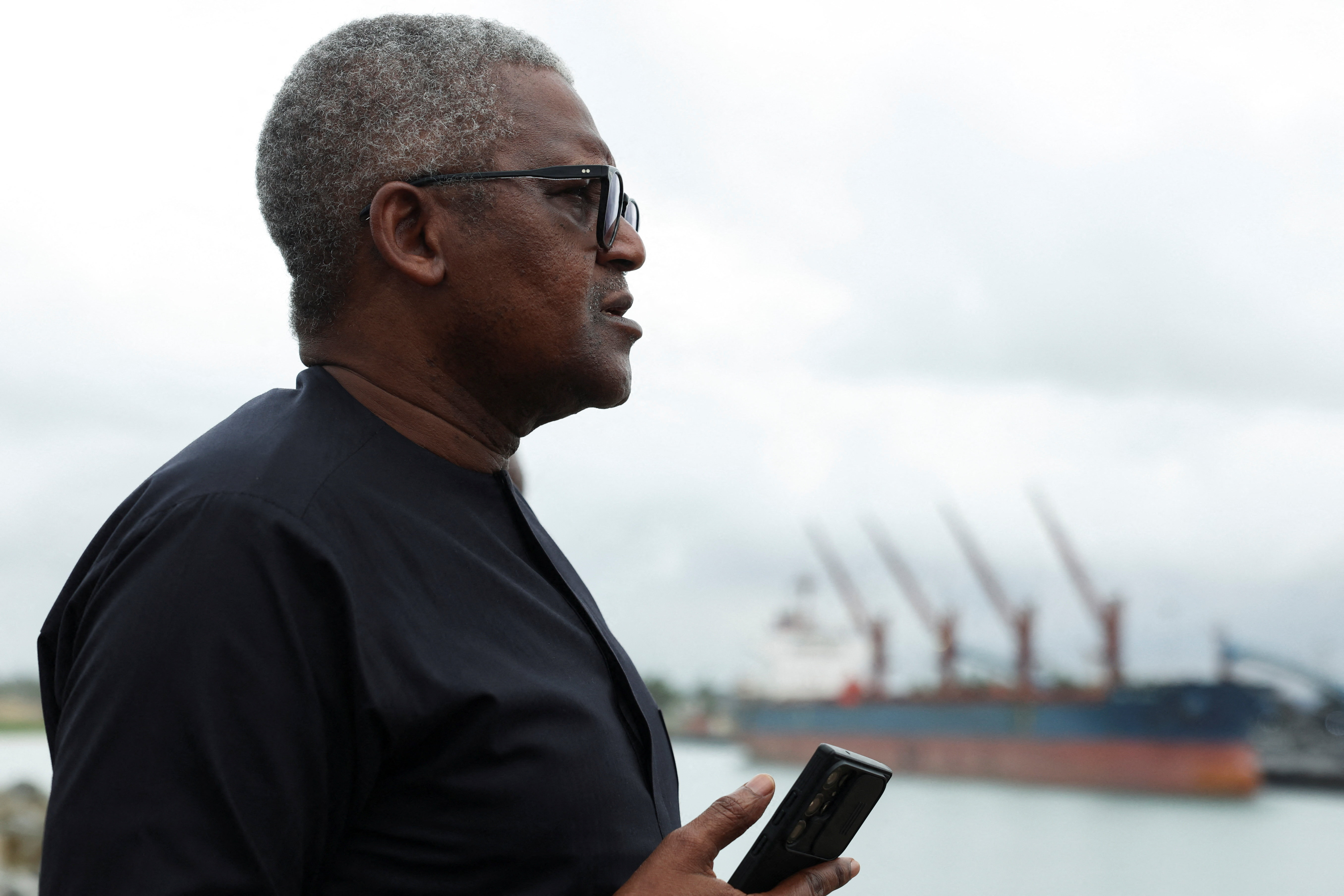 President and Chief Executive of Dangote Industries Limited, Aliko Dangote, looks on.