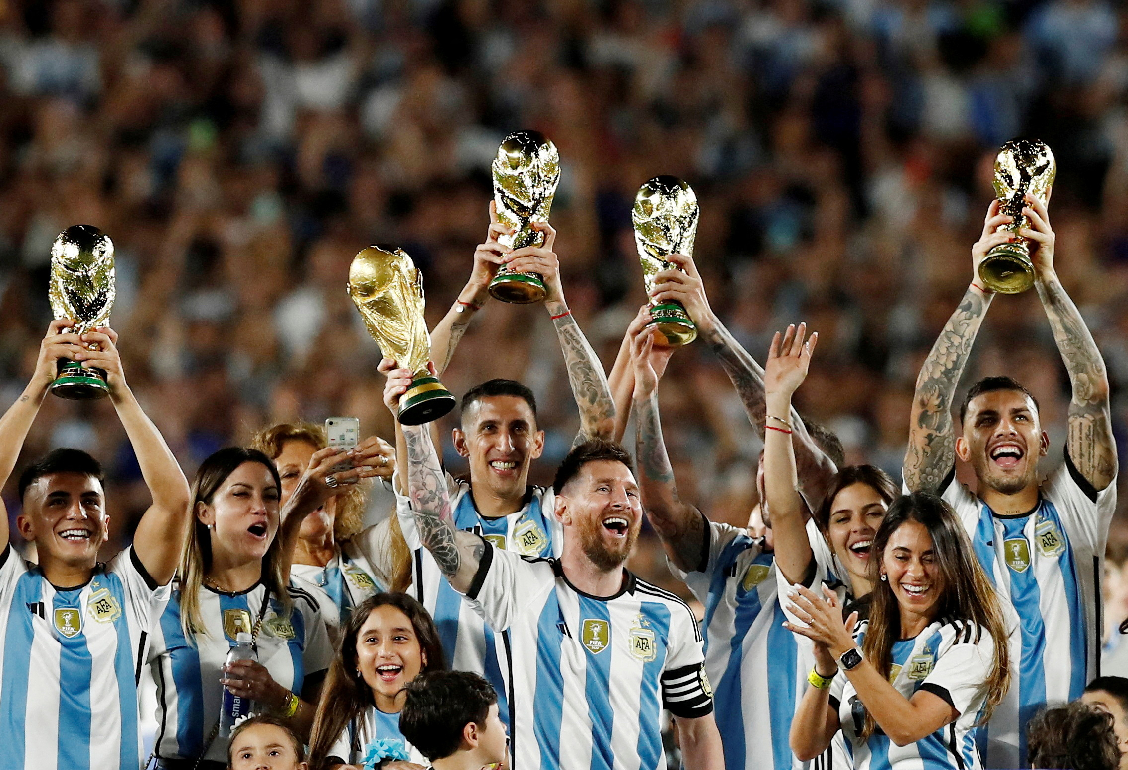 FILE PHOTO: Soccer Football - International Friendly - Argentina v Panama - Estadio Monumental, Buenos Aires, Argentina - March 23, 2023 Argentina's Lionel Messi and teammates celebrate with their families and World Cup trophies after the match REUTERS/Agustin Marcarian/File Photo