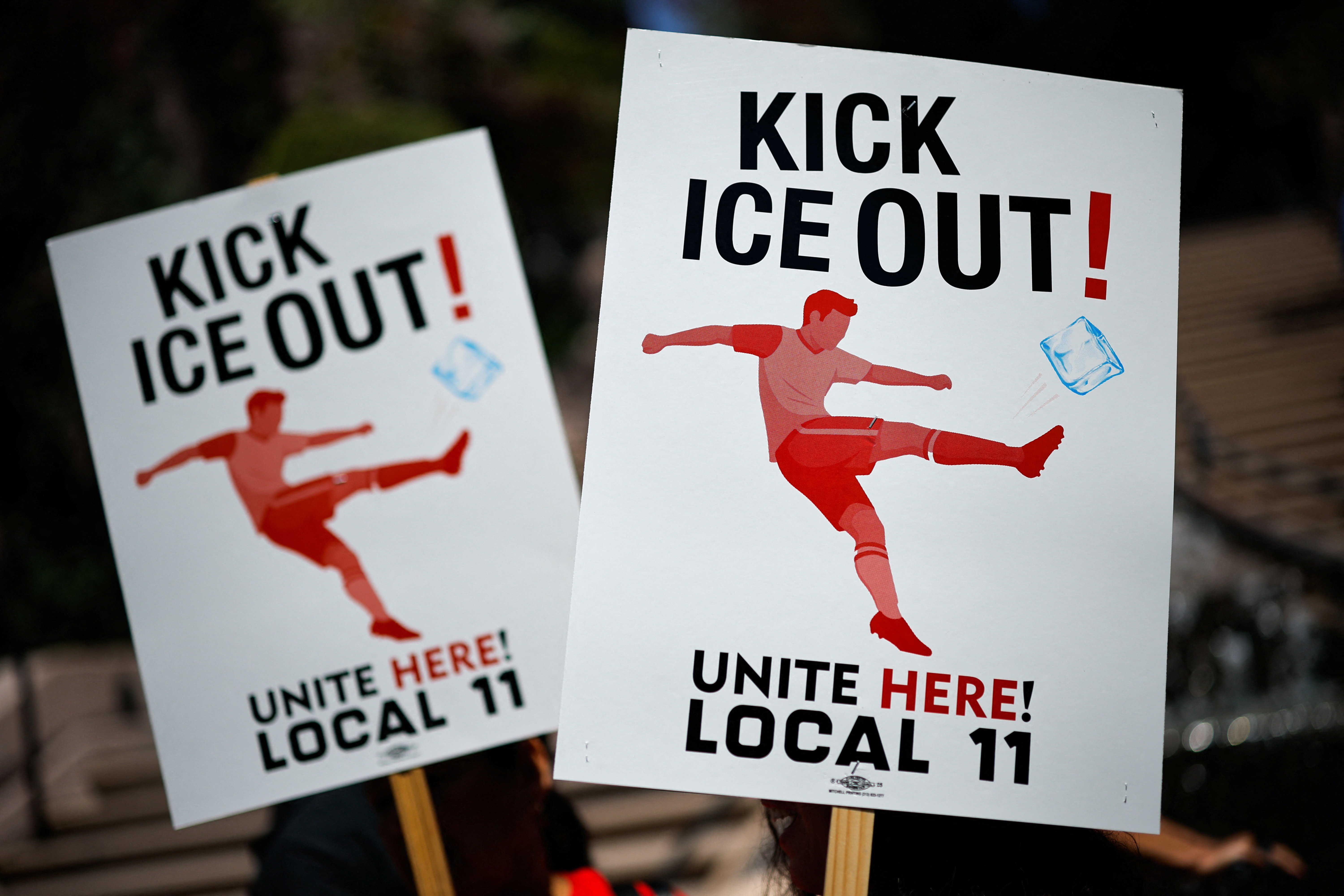 Signs are displayed reading "Kick ICE Out" in a protest.