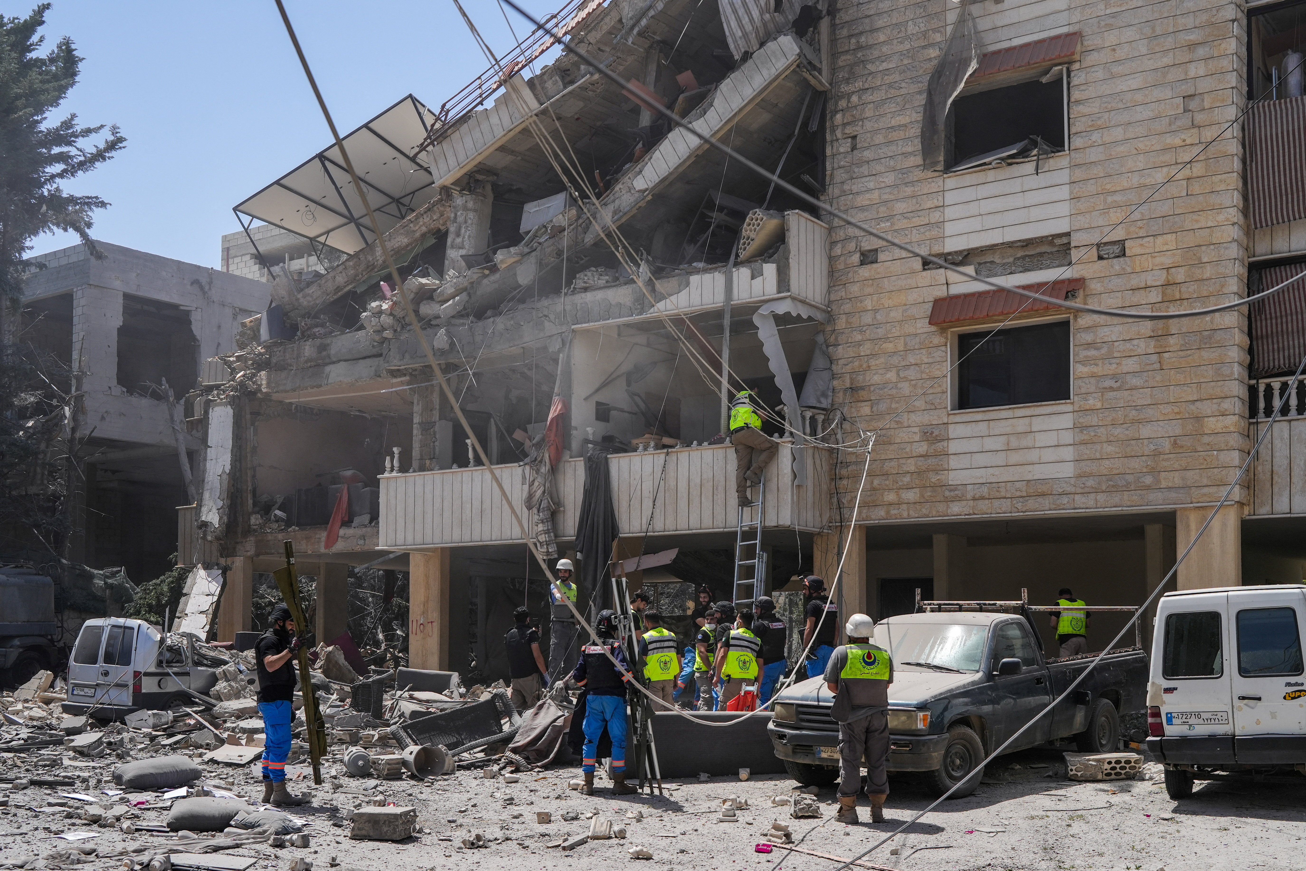 Rescuers work at the site of an Israeli strike in Kfar Jouz, Lebanon
