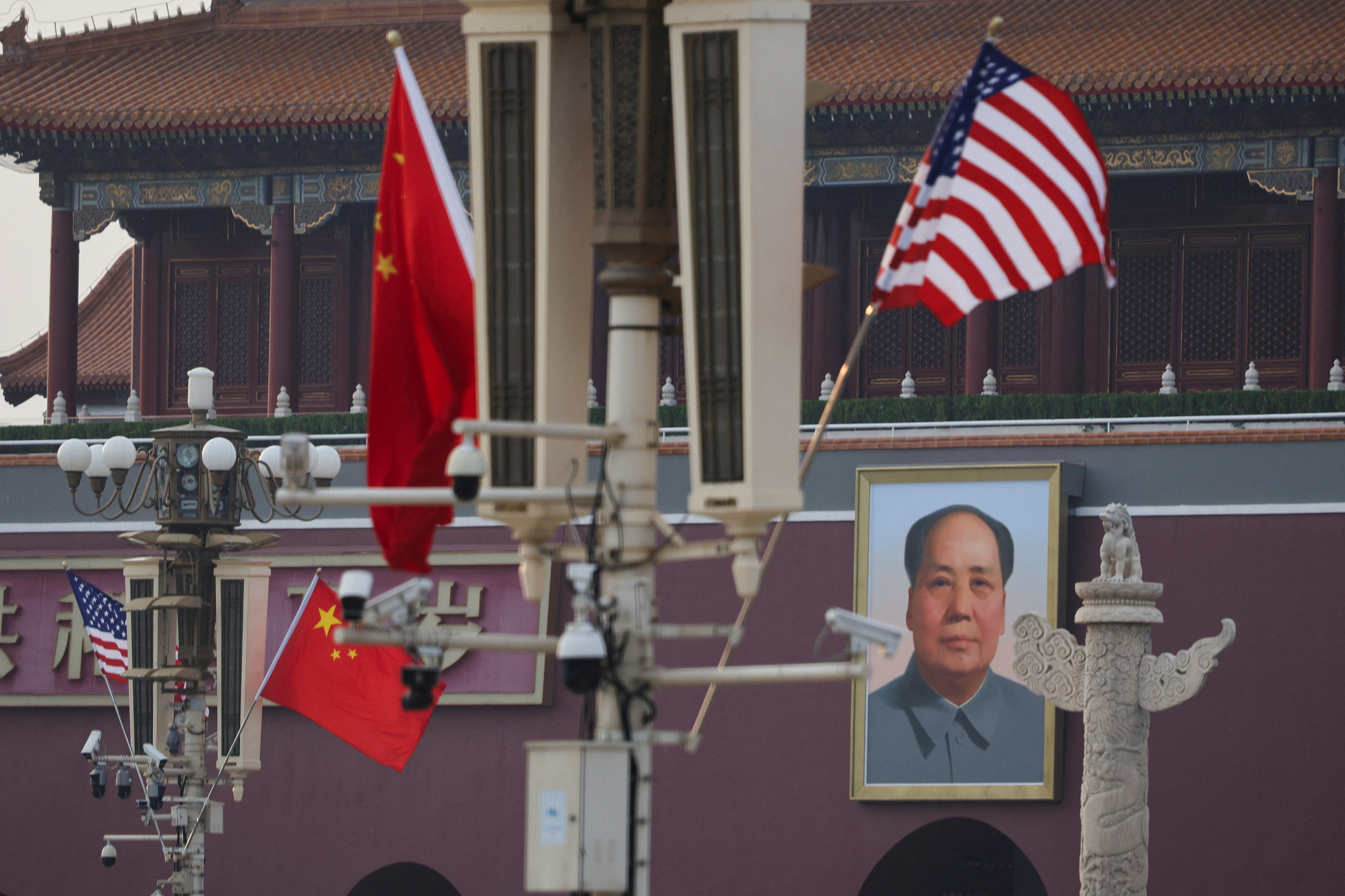 U.S. and Chinese national flags flutter next to the portrait of late Chinese Chairman Mao Zedong, ahead of U.S. President Donald Trump's visit to China, in Beijing, China, May 13, 2026.