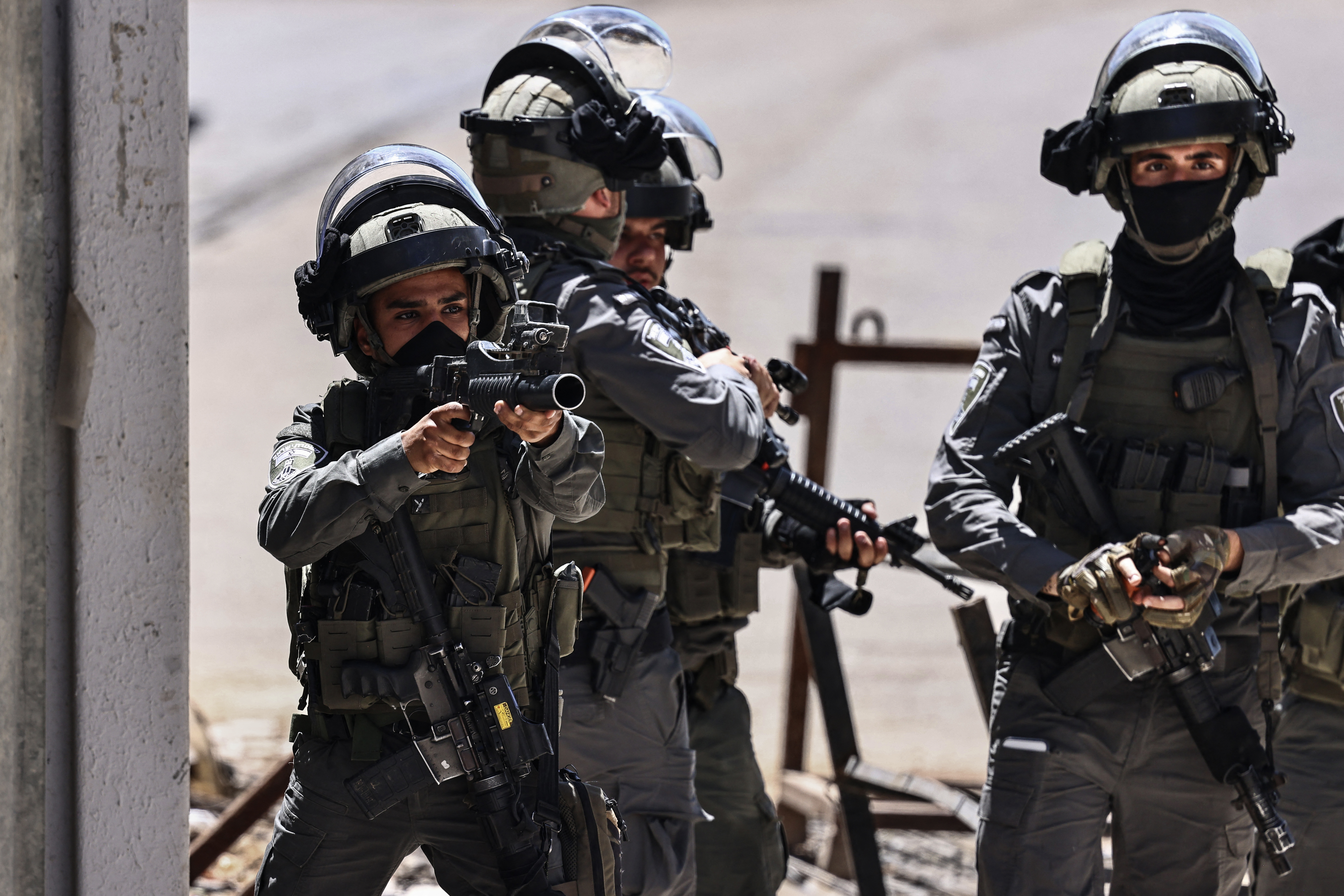 A member of the Israeli security forces aims his weapon while patrolling during a military raid in the Qalandia refugee camp, south of Ramallah in the Israeli-occupied West Bank, on May 11, 2026. The Israeli-occupied West Bank has been gripped by almost daily violence since the start of the Gaza war in October 2023, involving both Israeli troops and settlers. [Zain Jaafar/ AFP]