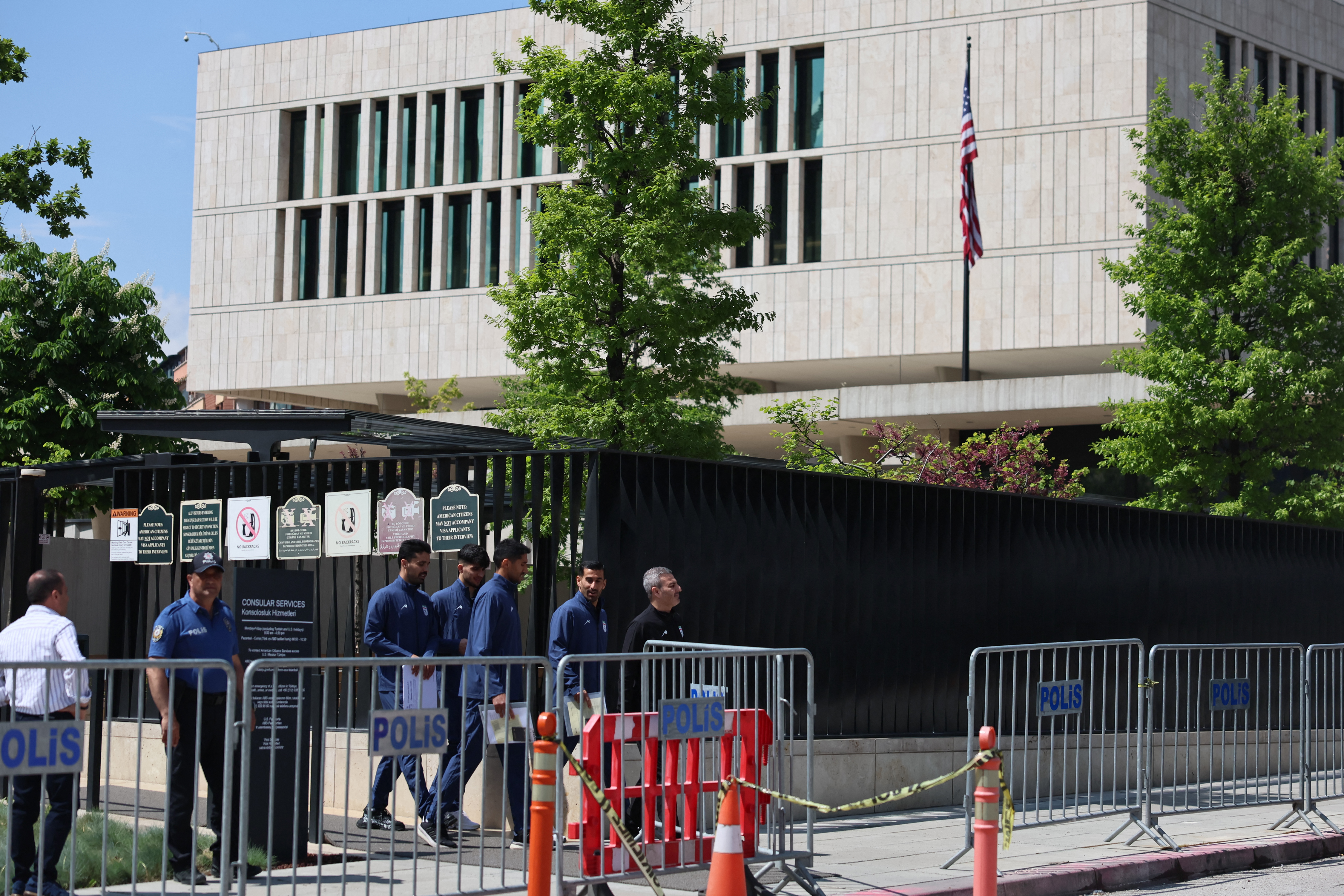 Iran's national football team players and members of their delegation leave the US Embassy in Ankara after submitting their visa applications ahead of the 2026 FIFA World Cup, on May 21, 2026. The Iranian football federation vice-president said on May 20, 2026 he was "very confident" in FIFA's protocols as the team prepare to play at the World Cup in the United States. The players are to stay several weeks before heading to the World Cup that is being co-hosted by the US, which began bombing Iran on February 28 alongside Israel, sparking a wider war in the Middle East. (Photo by Adem ALTAN / AFP)