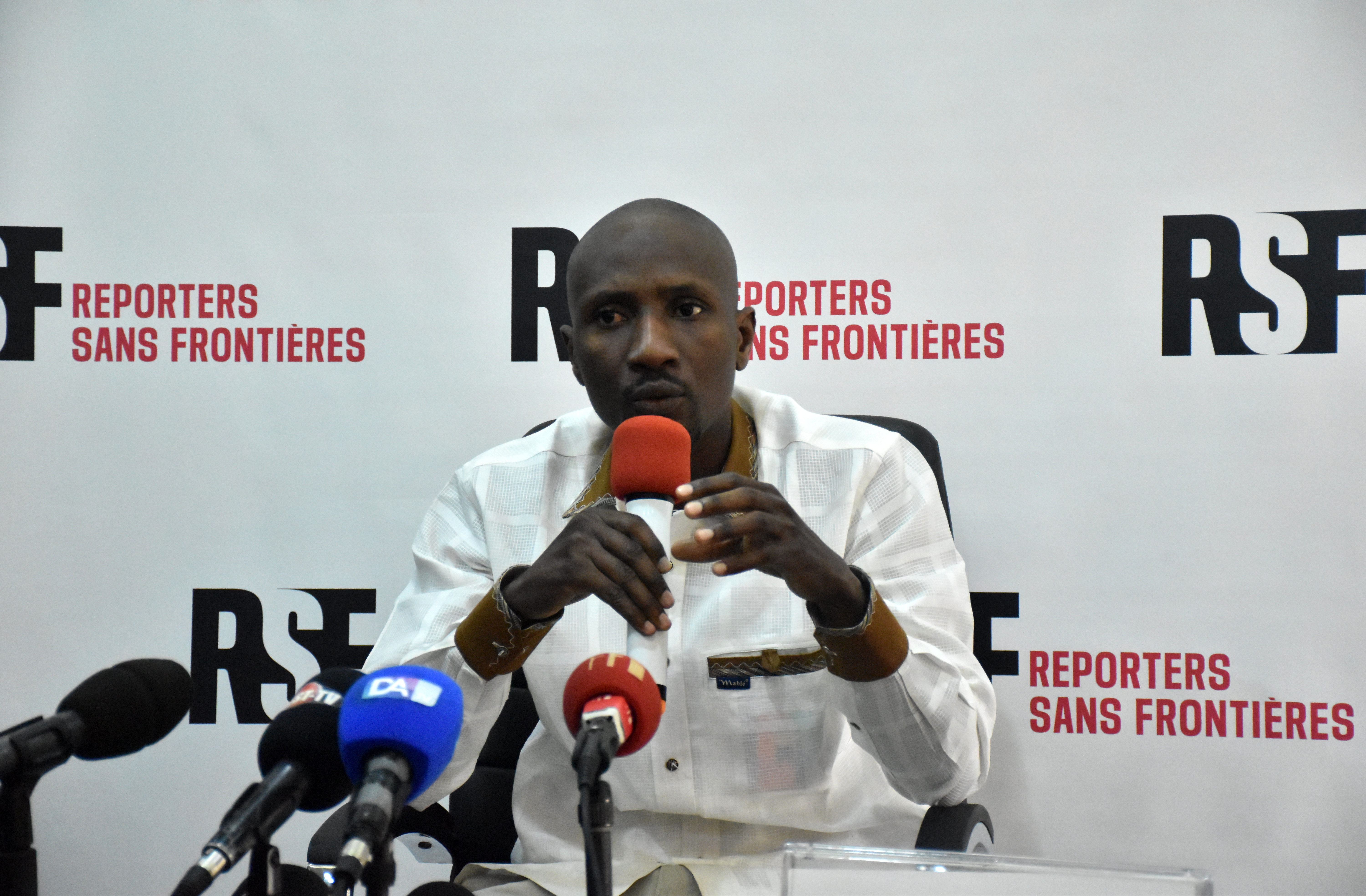 Burkinabe journalist Atiana Serge Oulon speaks at a news conference in Dakar