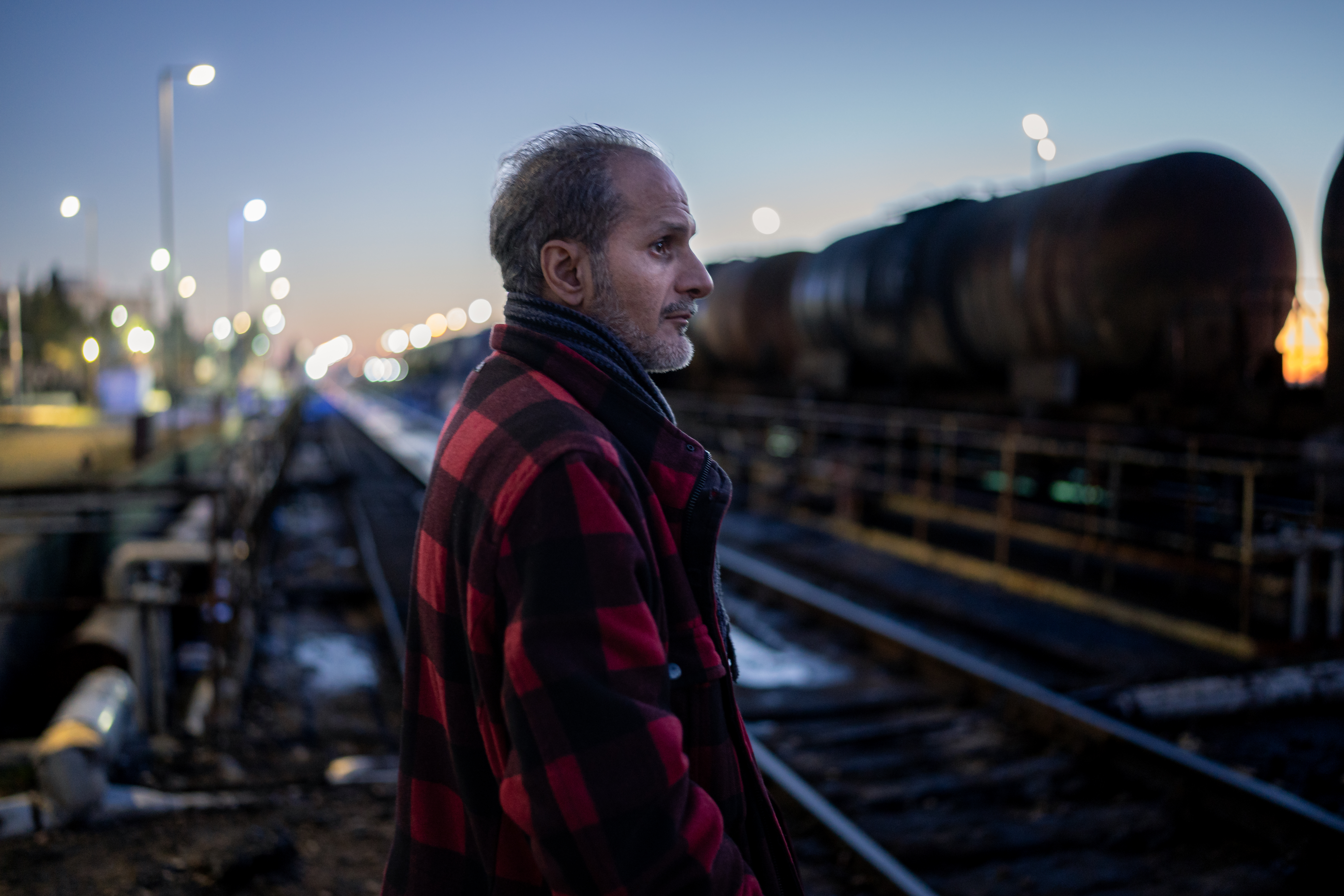 Ahmed Hamami, driver of the third crew, contemplates the rising sun as the fuel is unloaded at the Aleppo Thermal Power Plant [Charles Cuau/Al Jazeera]