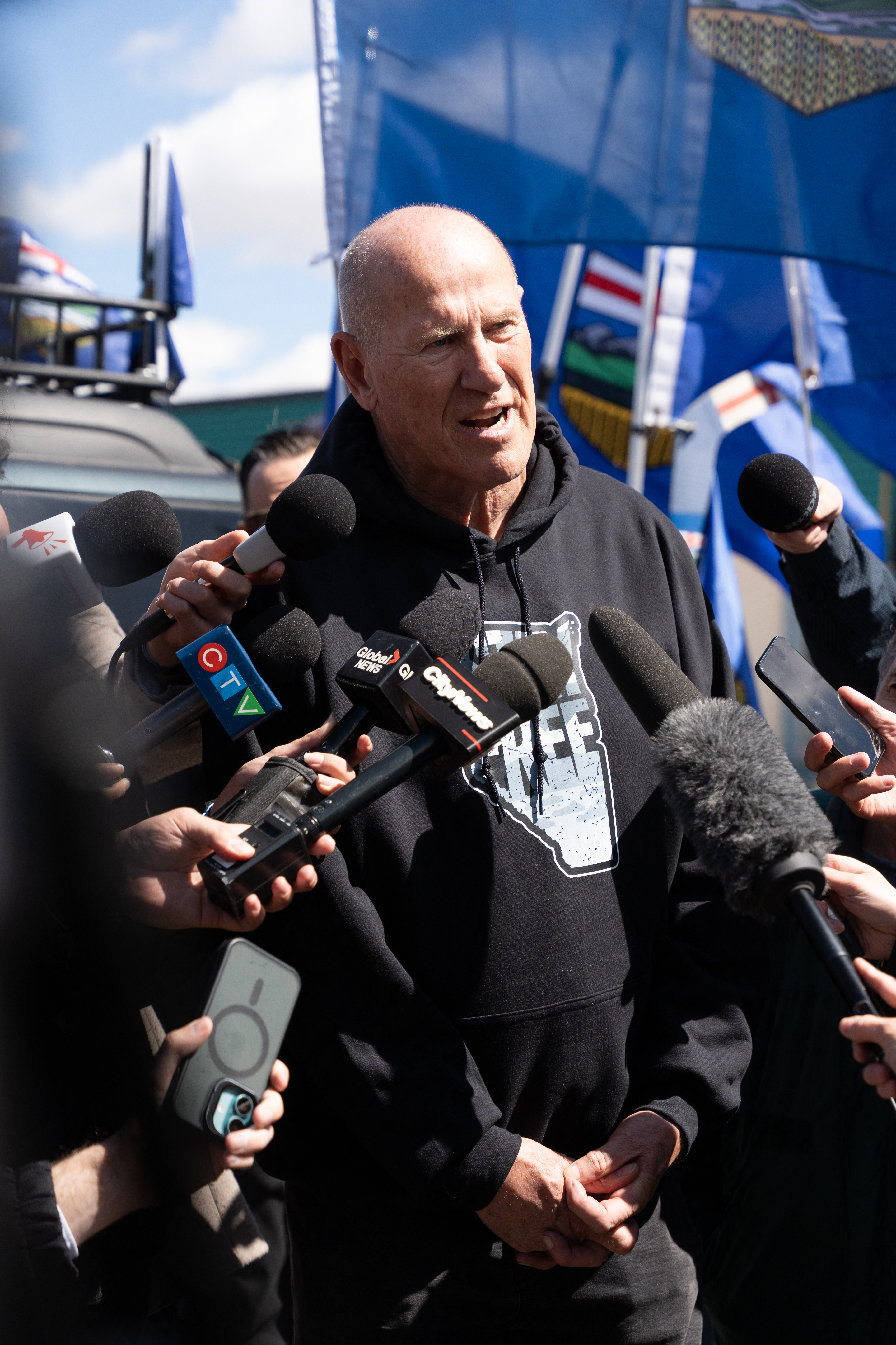 Separatist leader Mitch Sylvestre speaks to reporters as he leads a rally in front of the Elections Alberta headquarters in Edmonton, Canada, on May 4, 2026, as they submit boxes of signatures in the hope of triggering an independence referendum.